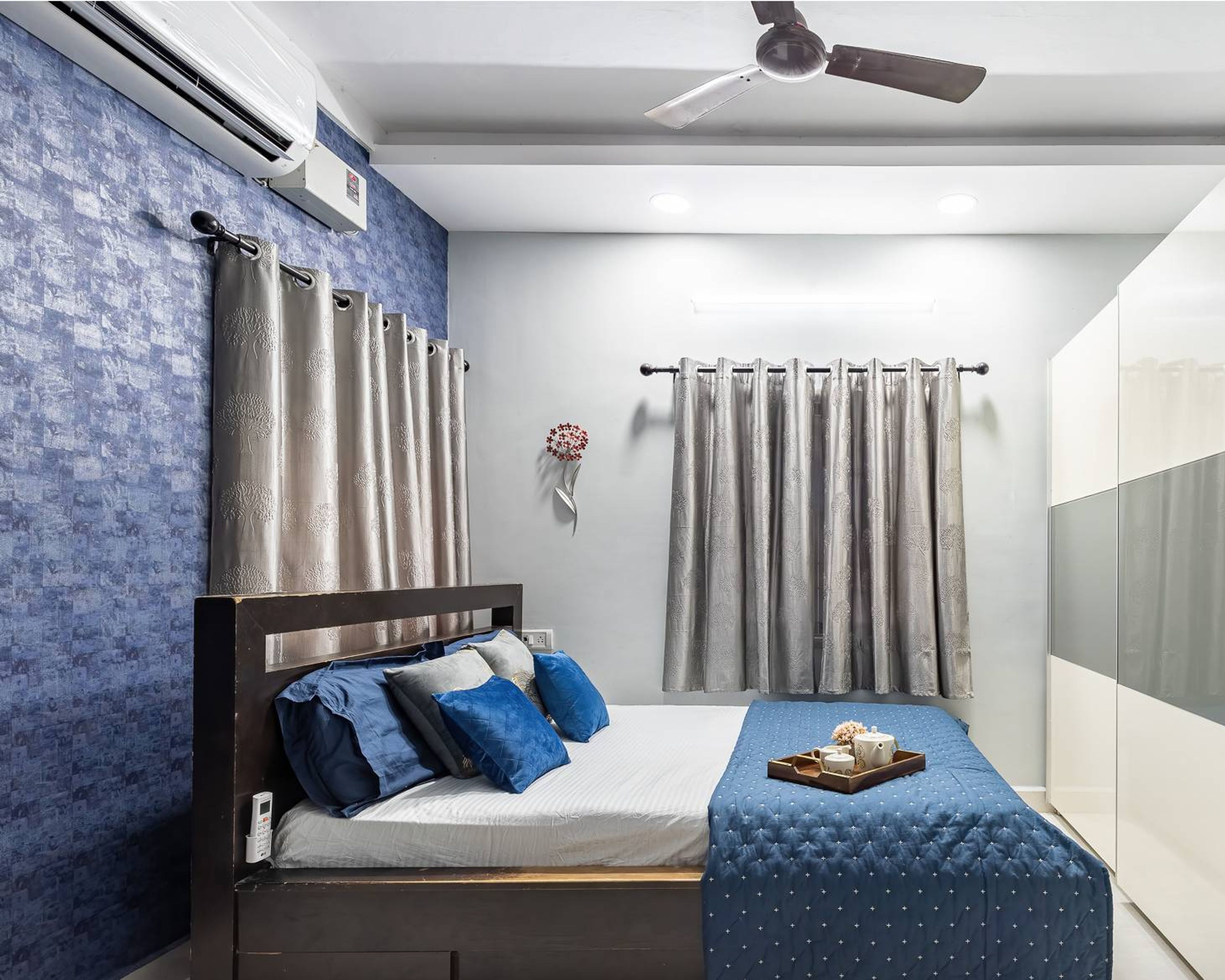 Modern Guest Bedroom Design With Double Sized Bed And Blue Accent Wall