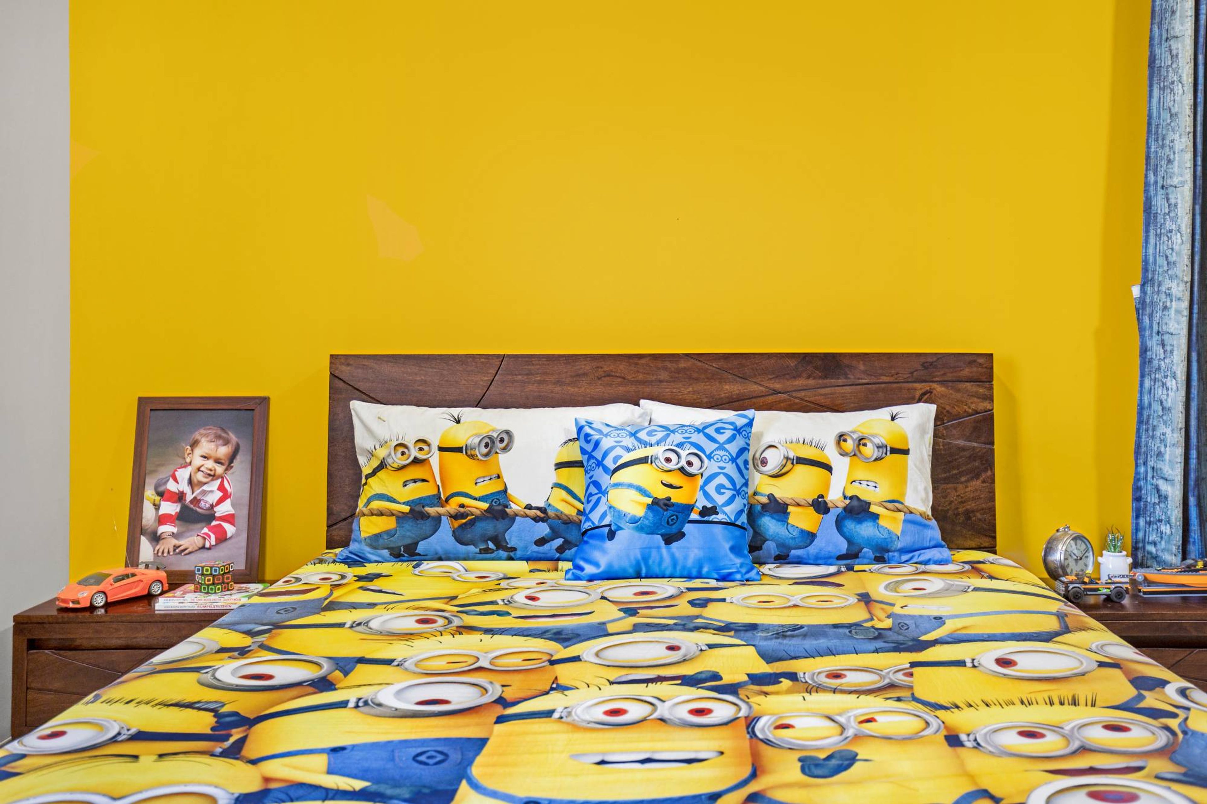 Modern Kids Room Design With Bright Yellow Walls And A Double Bed