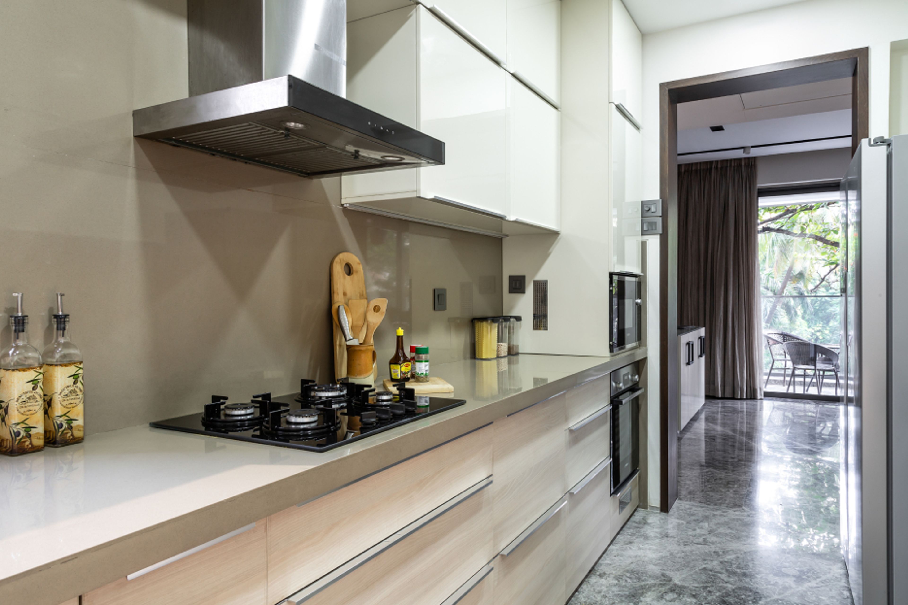Contemporary Parallel Kitchen Design With Beige Backsplash Tiles