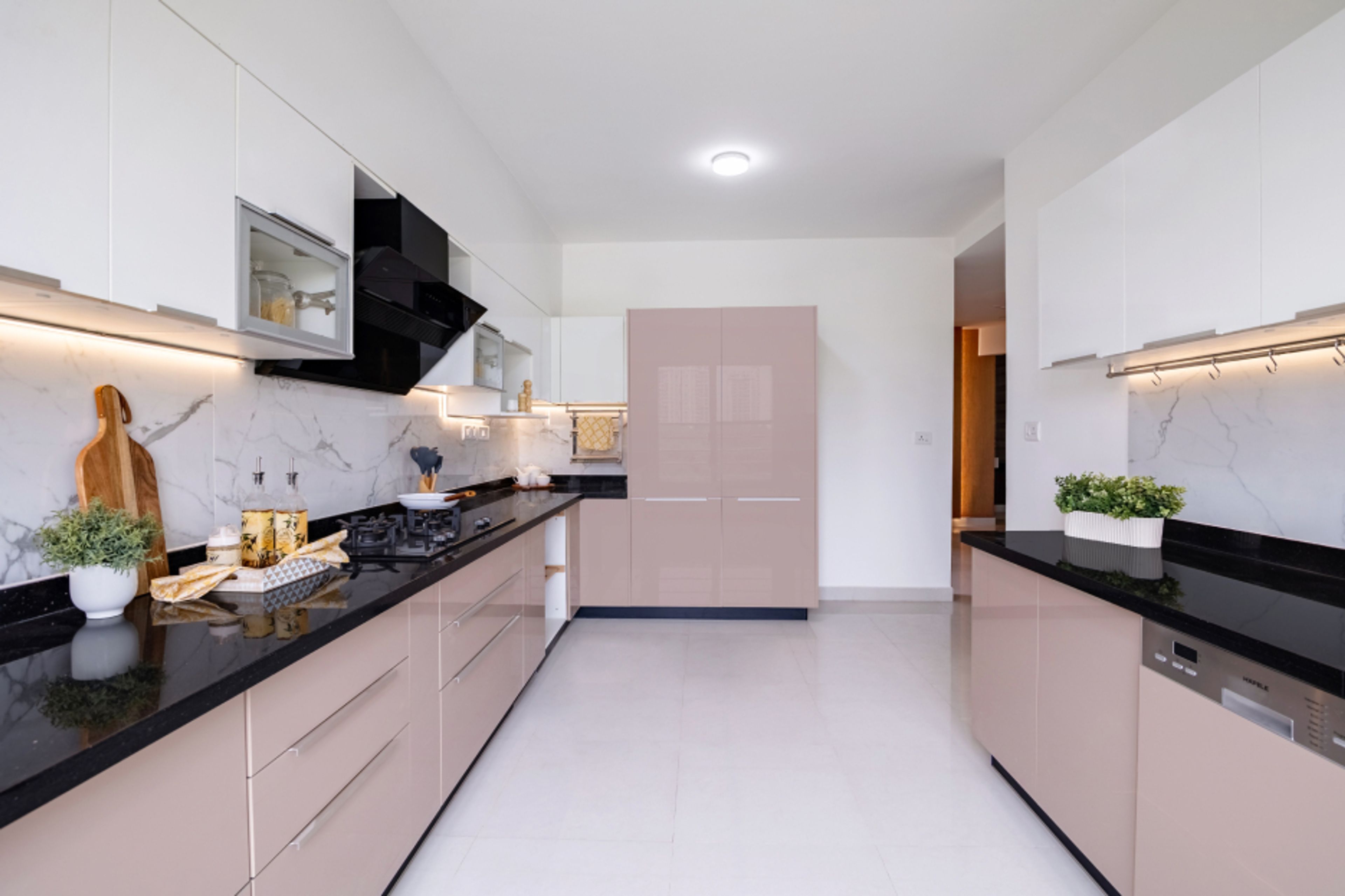 Contemporary Parallel Kitchen Design With White Marble Backsplash Tiles And Cove Lighting