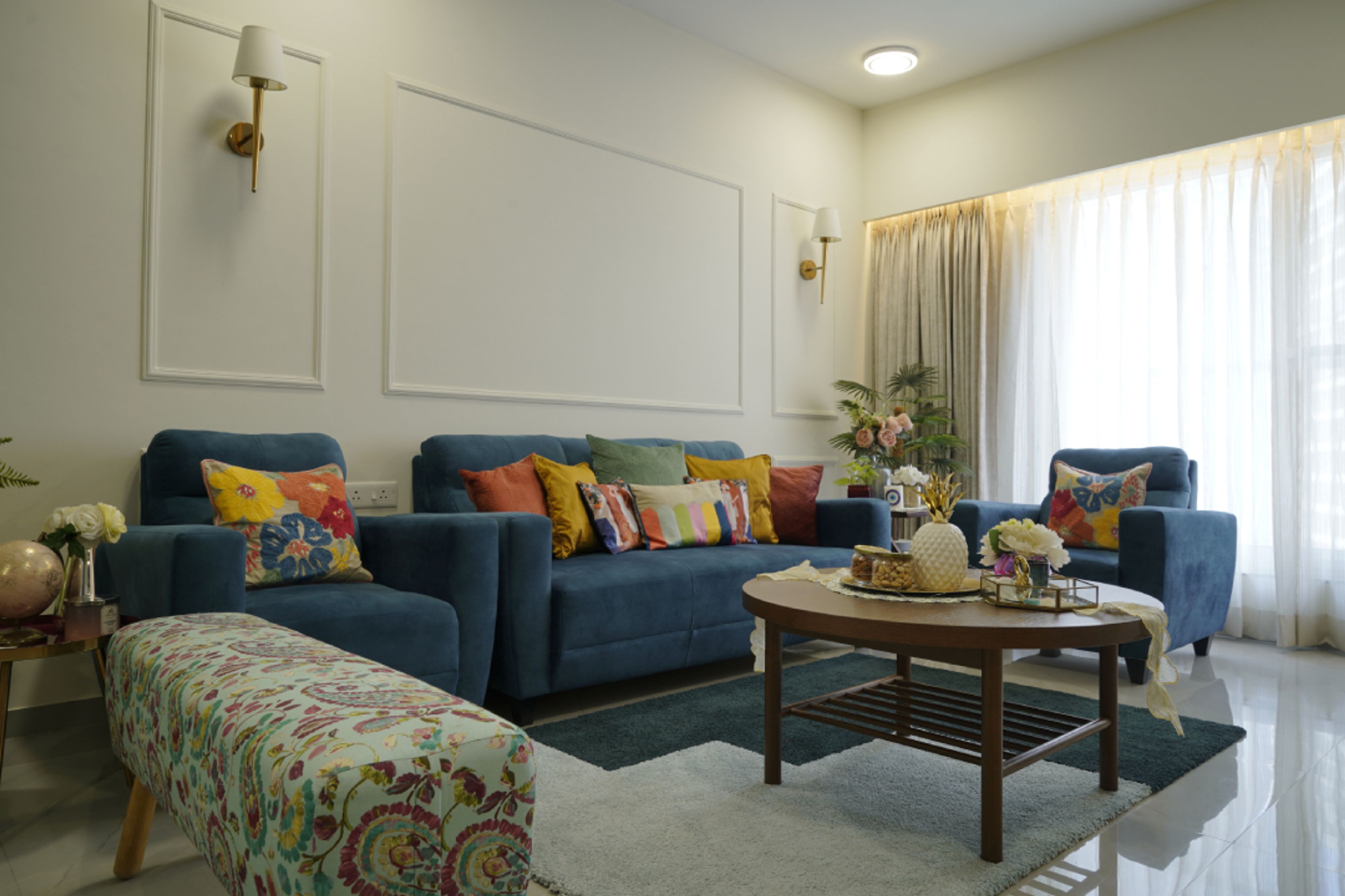Living Room With Blue Upholstered Sofa And A Wooden Center Table - Livspace