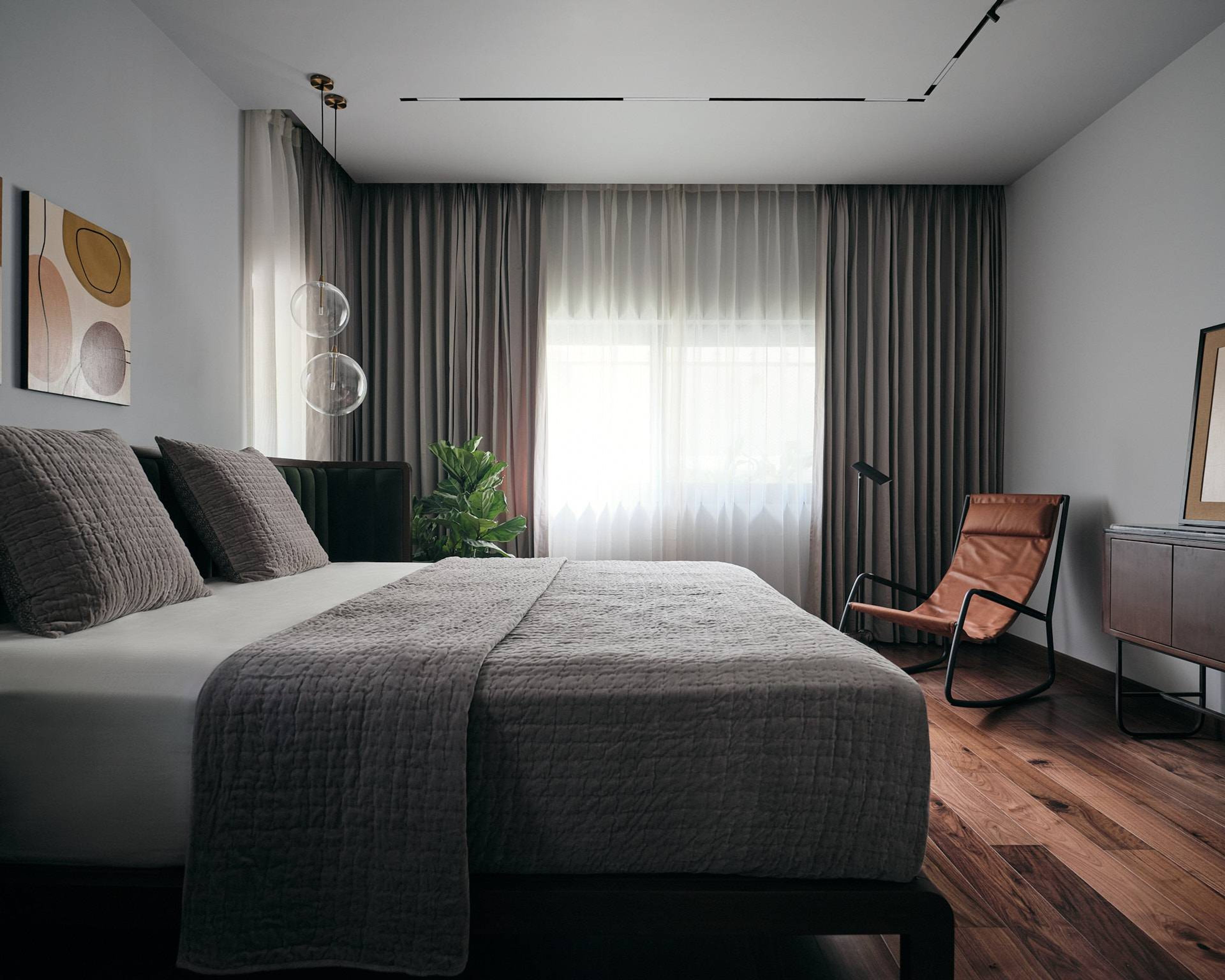 Master Bedroom Design With A King Size Bed And Leather Chair - Livspace