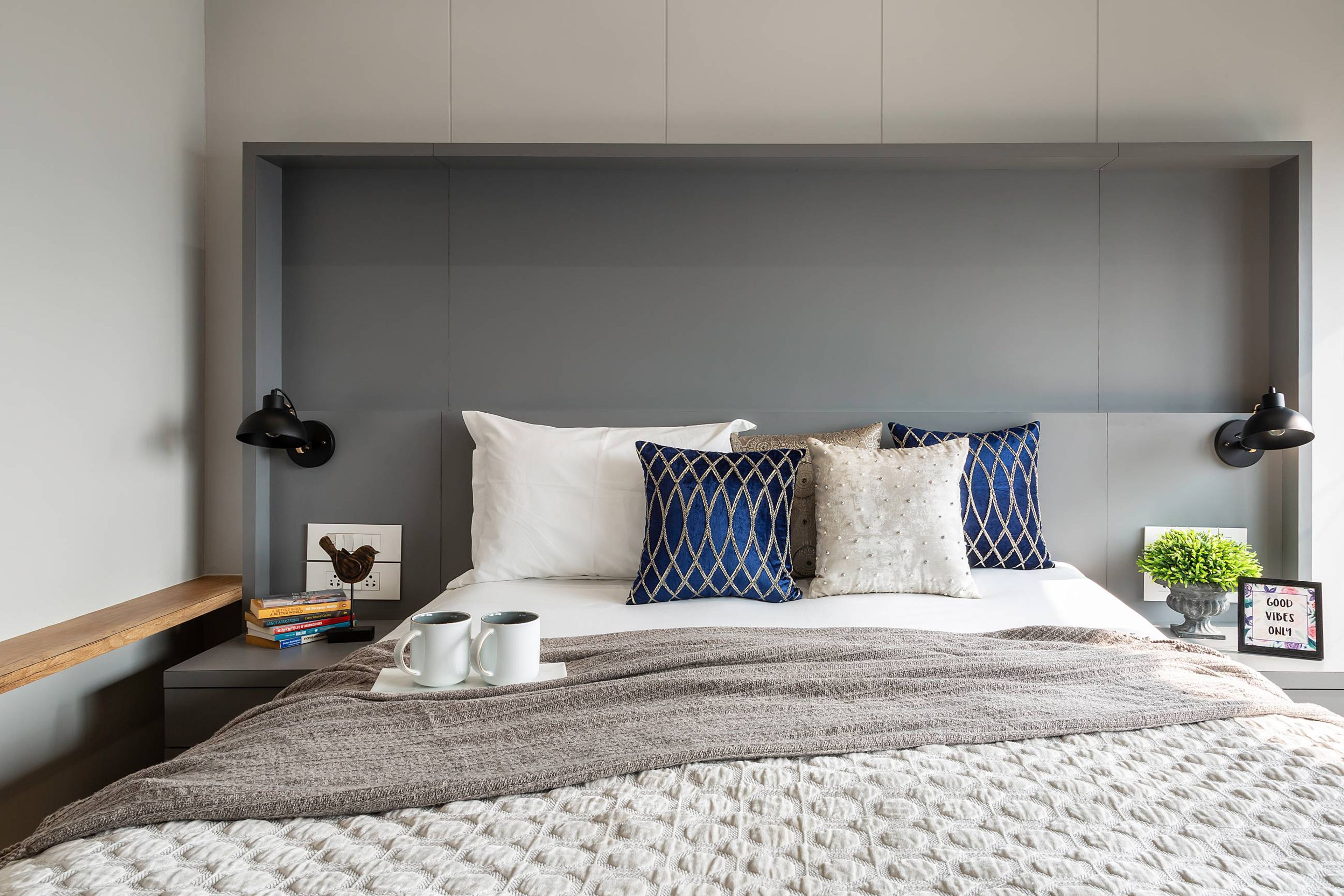 Modern Bedroom Design With A King Size Bed With A Grey Tufted Headboard