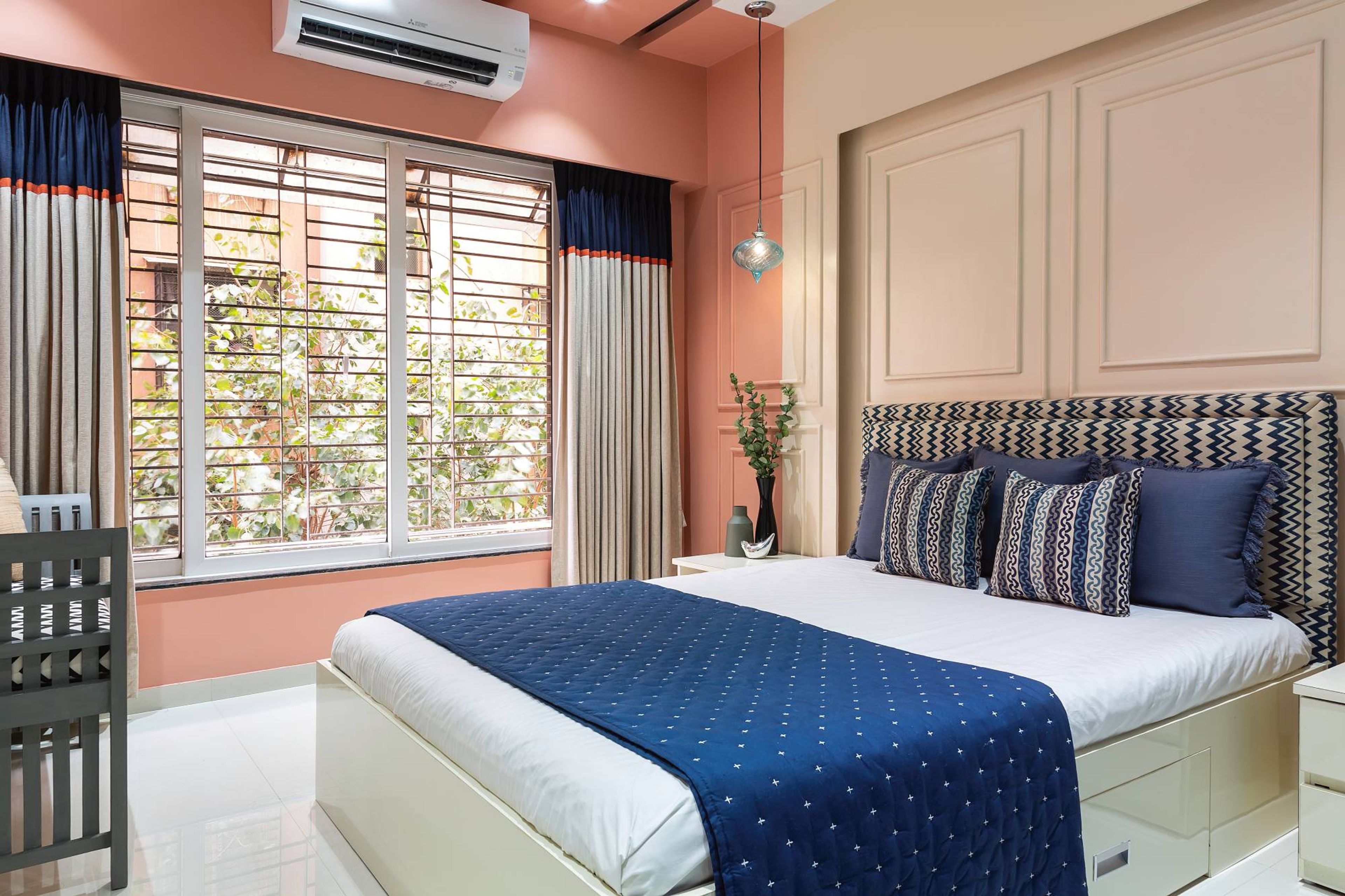 Bedroom Design With Double Bed And Peach Wall Paint With Trims - Livspace