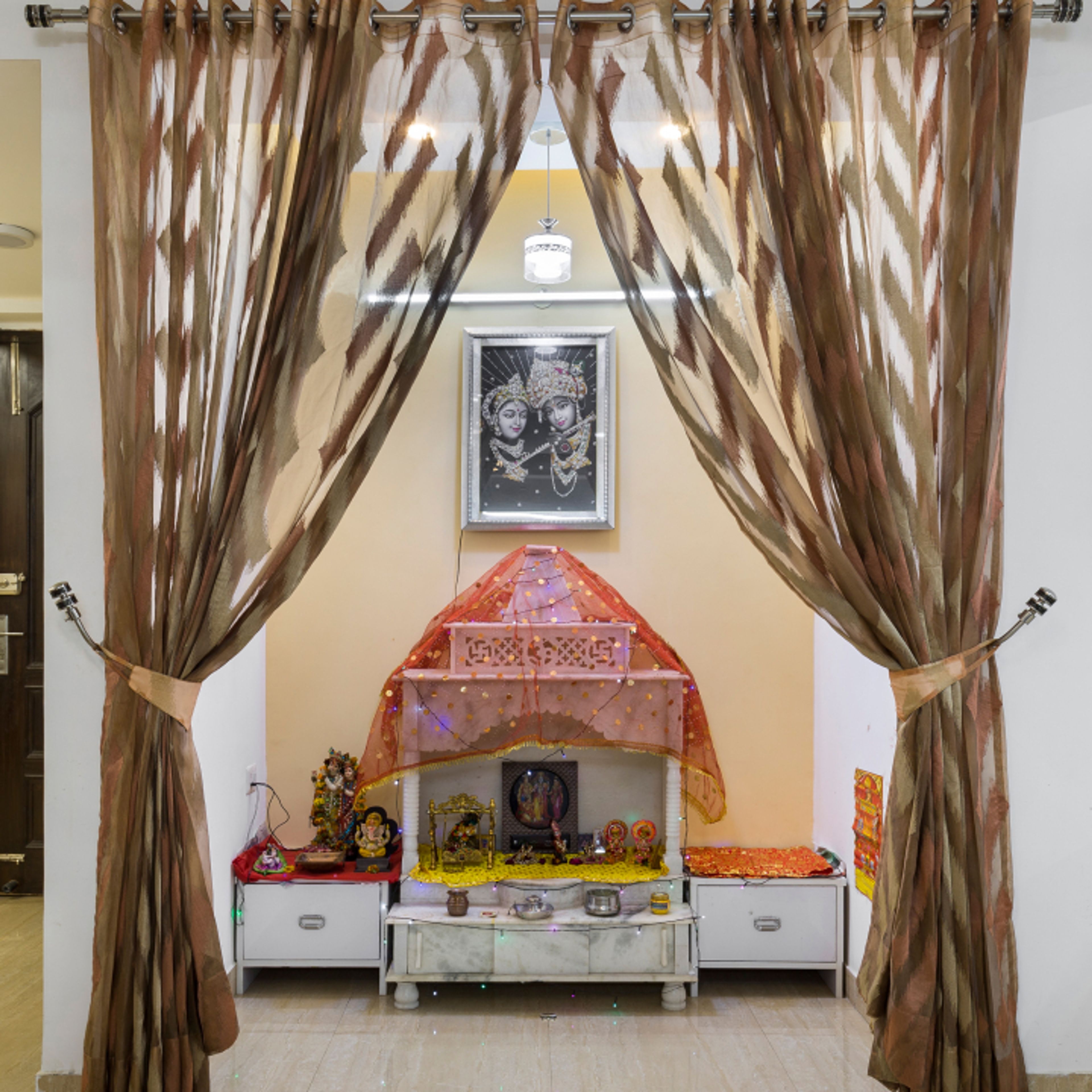 Traditional Pooja Room Design With Shutters And Pullout Drawers