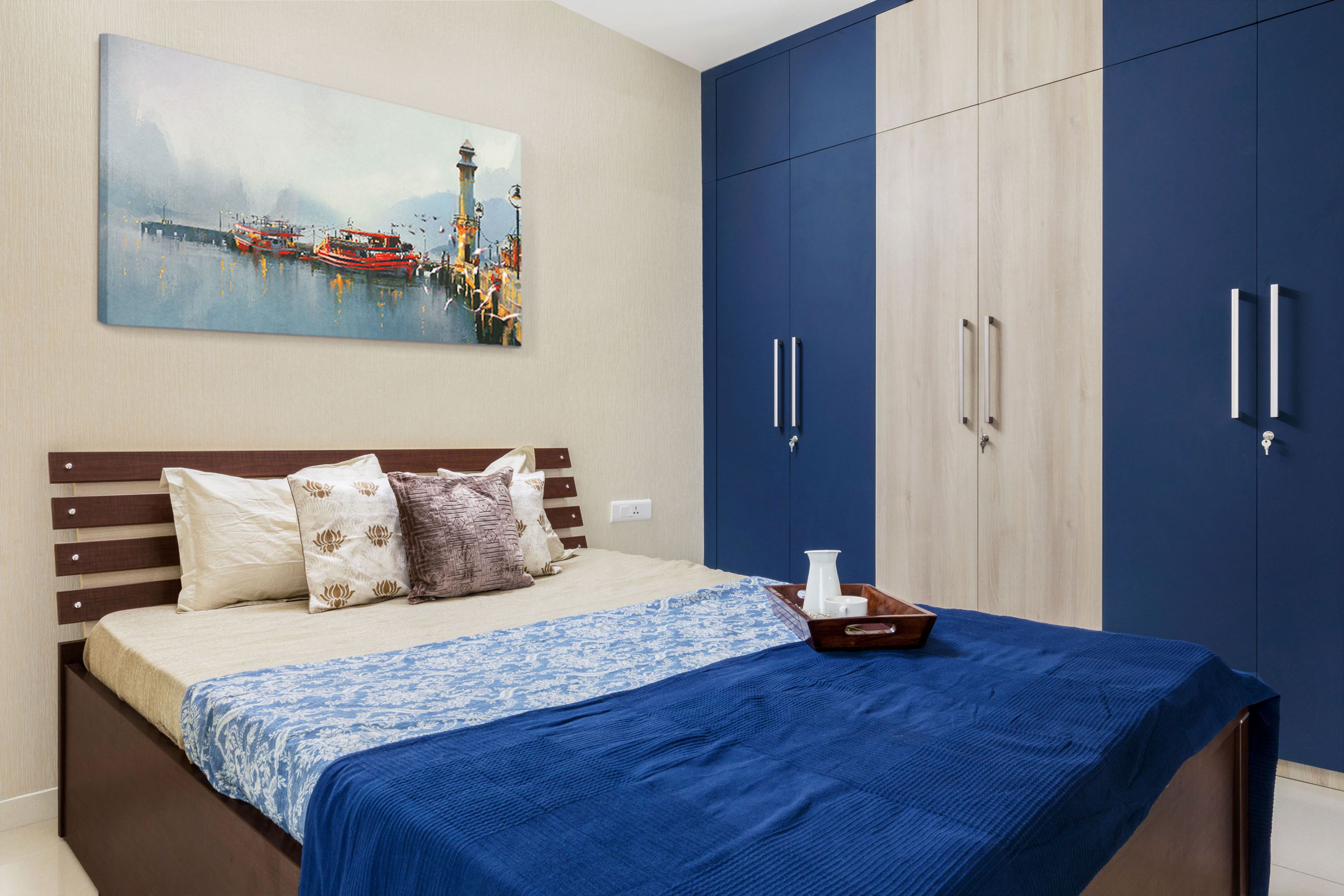 Spacious Guest Room Design With Wooden Bed And 6-Door Blue And Beige Swing Wardrobe - Livspace