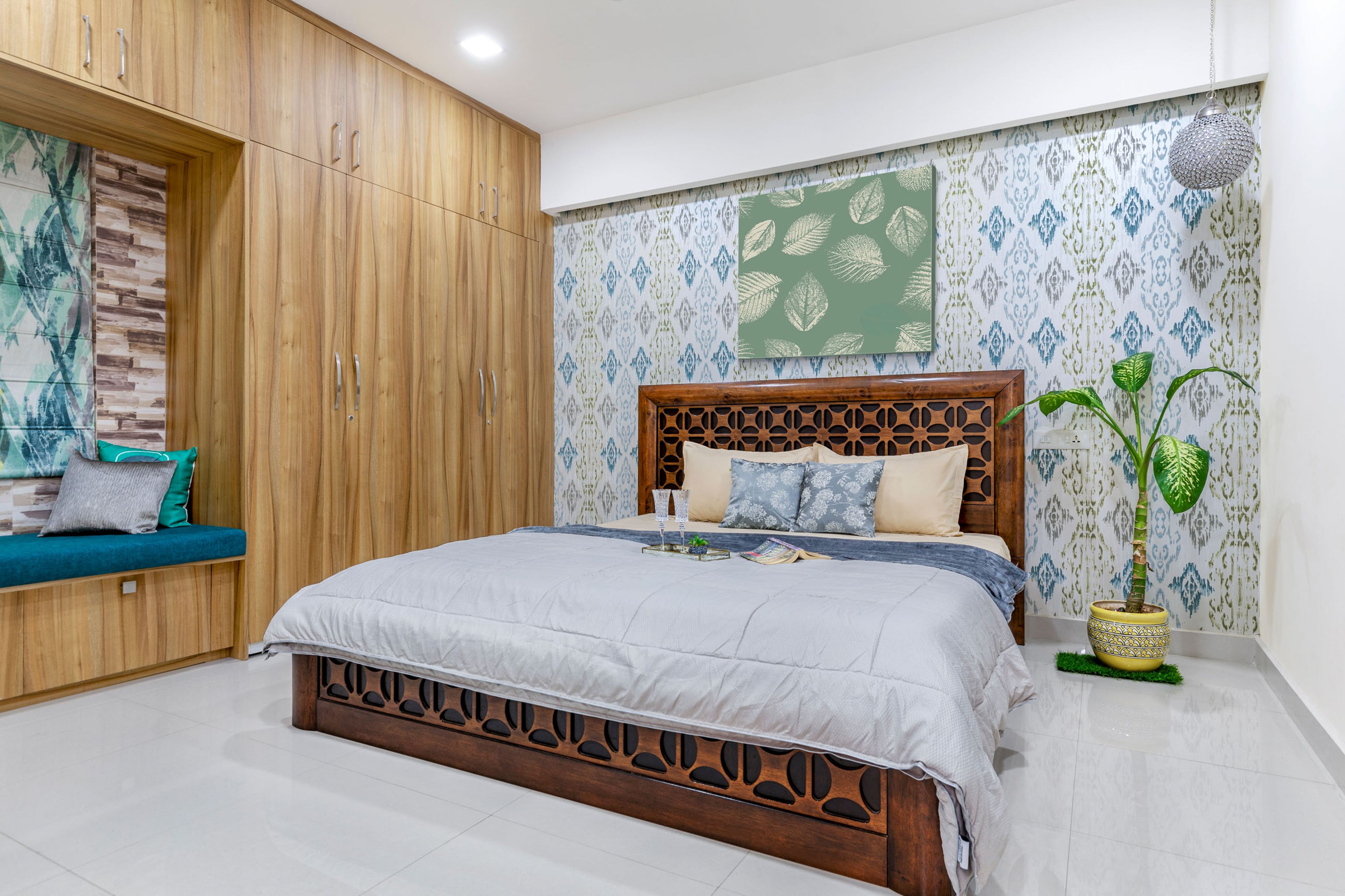Spacious Guest Bedroom Design With Ornate Wooden Bed, 8-Door Swing Wooden Wardrobe And Multicoloured Wallpaper - Livspace