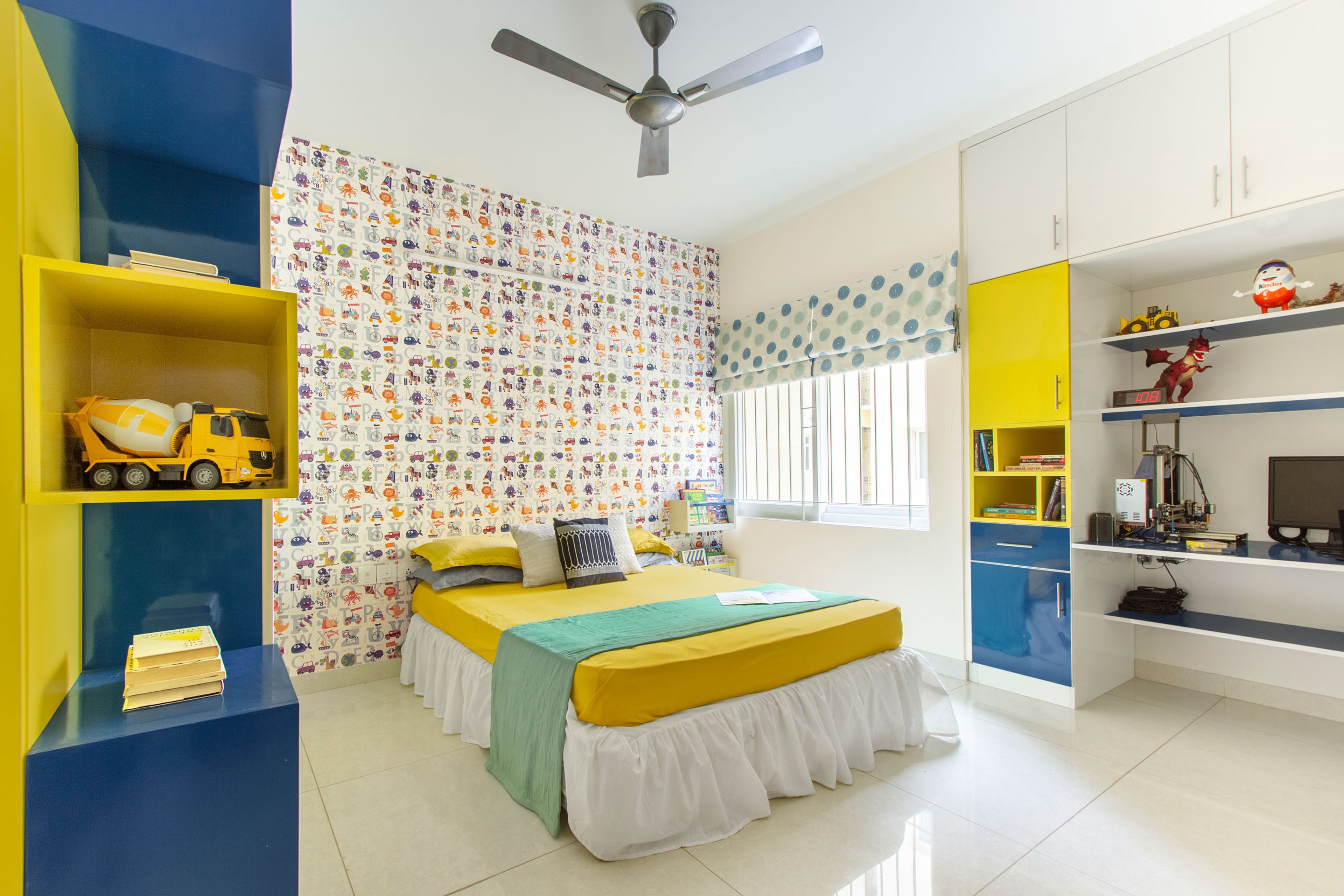 Blue And Yellow Kids Bedroom Design With Cartoon-Themed Wallpaper - Livspace