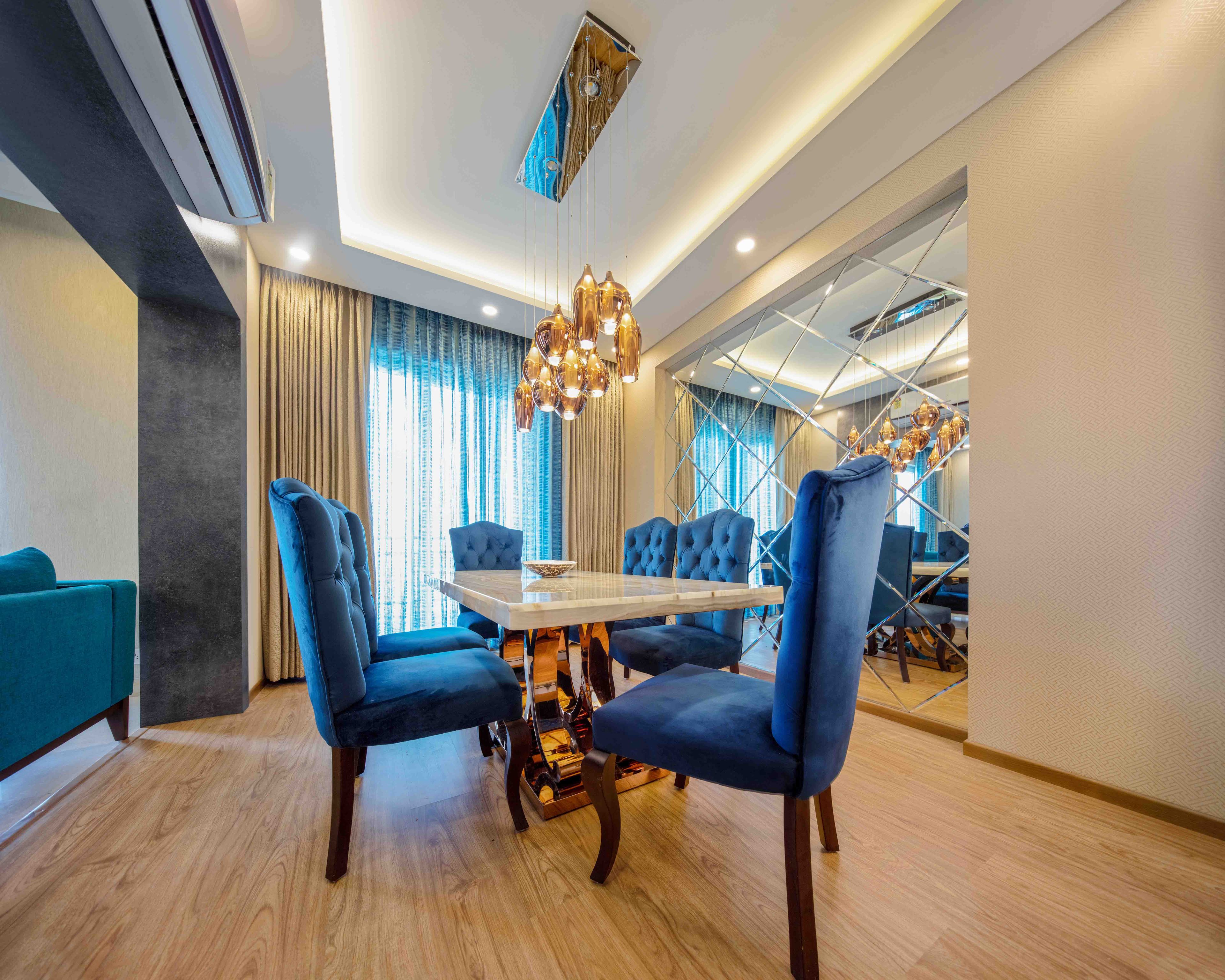 Contemporary 3-BHK Interior Design For Delhi Flat With 6-Seater Dining Table And Bevelled Mirrored Wall