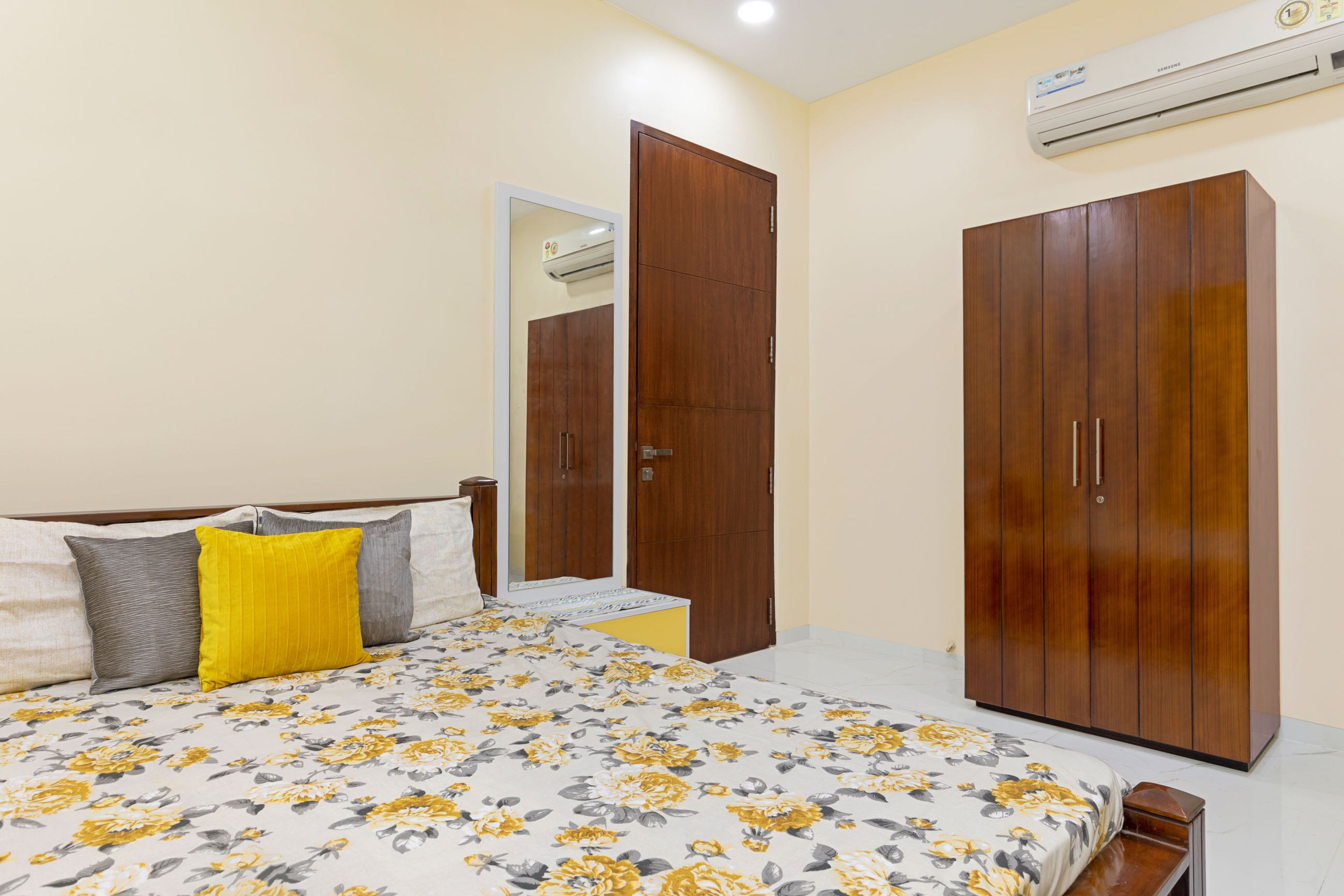 Floral Guest Bedroom Design With 2-Door Wooden Swing Wardrobe - Livspace