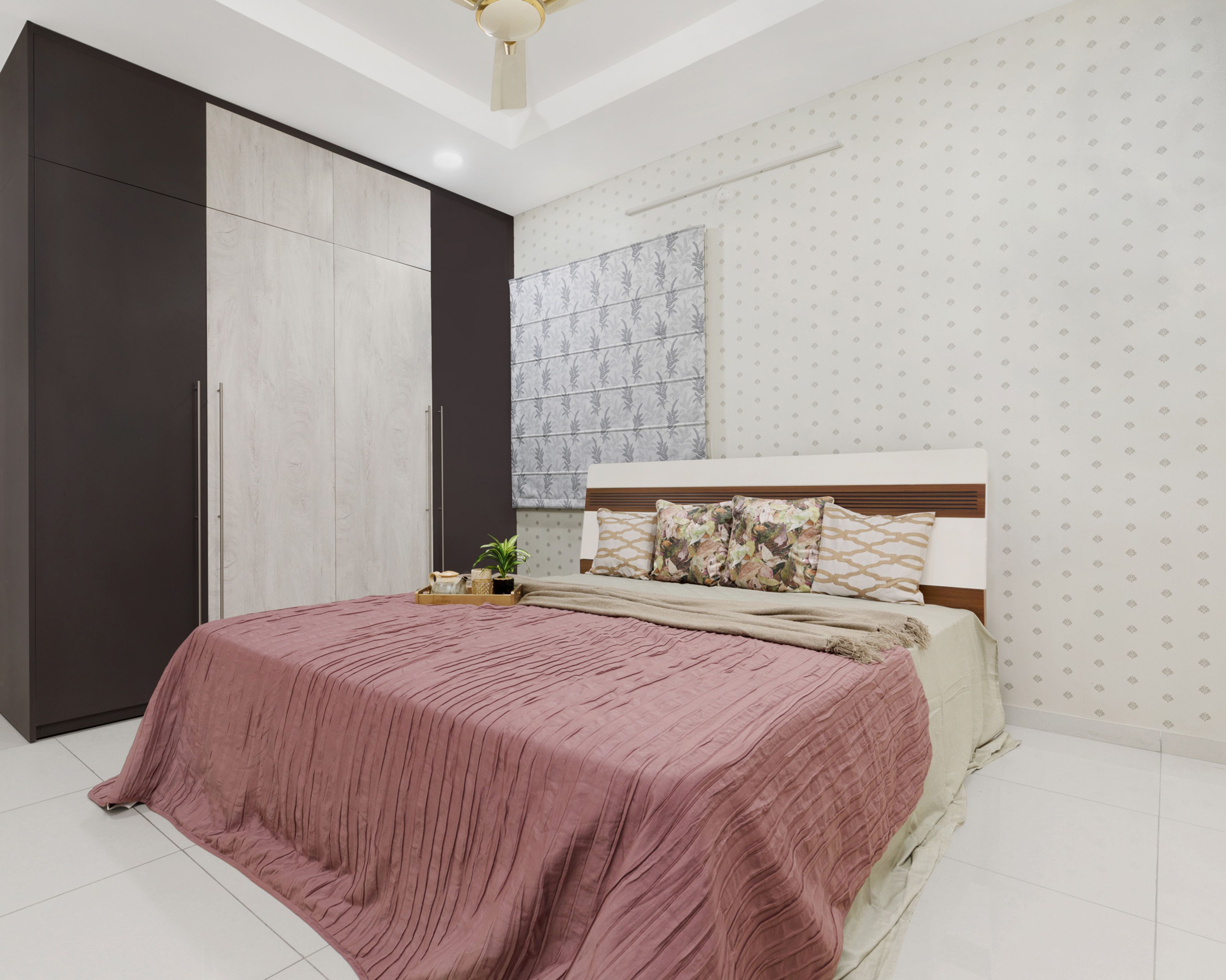 Pink master bedroom design with 4-door dark wood and light wood swing wardrobe - Livspace