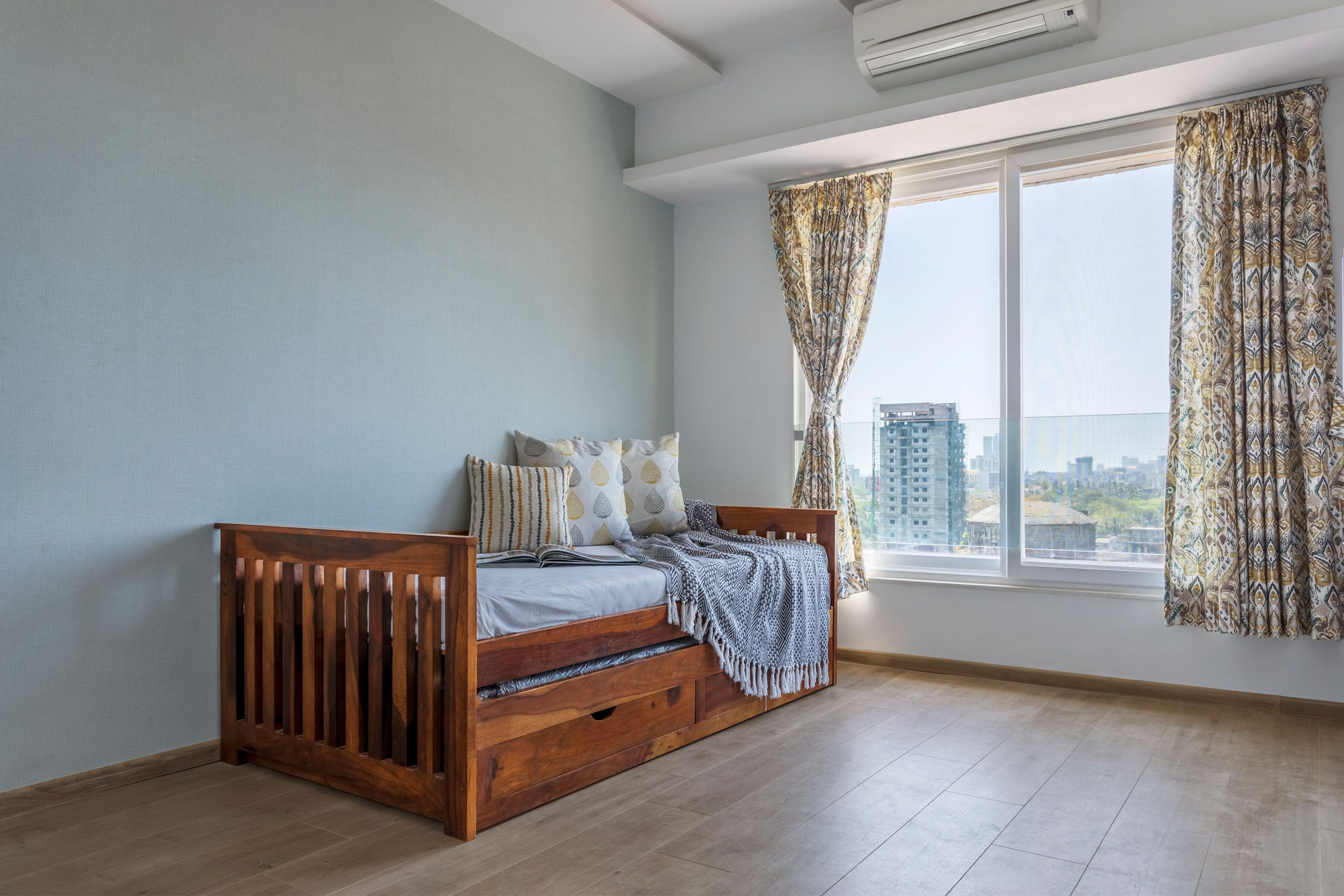 Kids Bedroom With Light Blue Accent Wall, Single Wooden Bed And Under-Bed Storage - Livspace