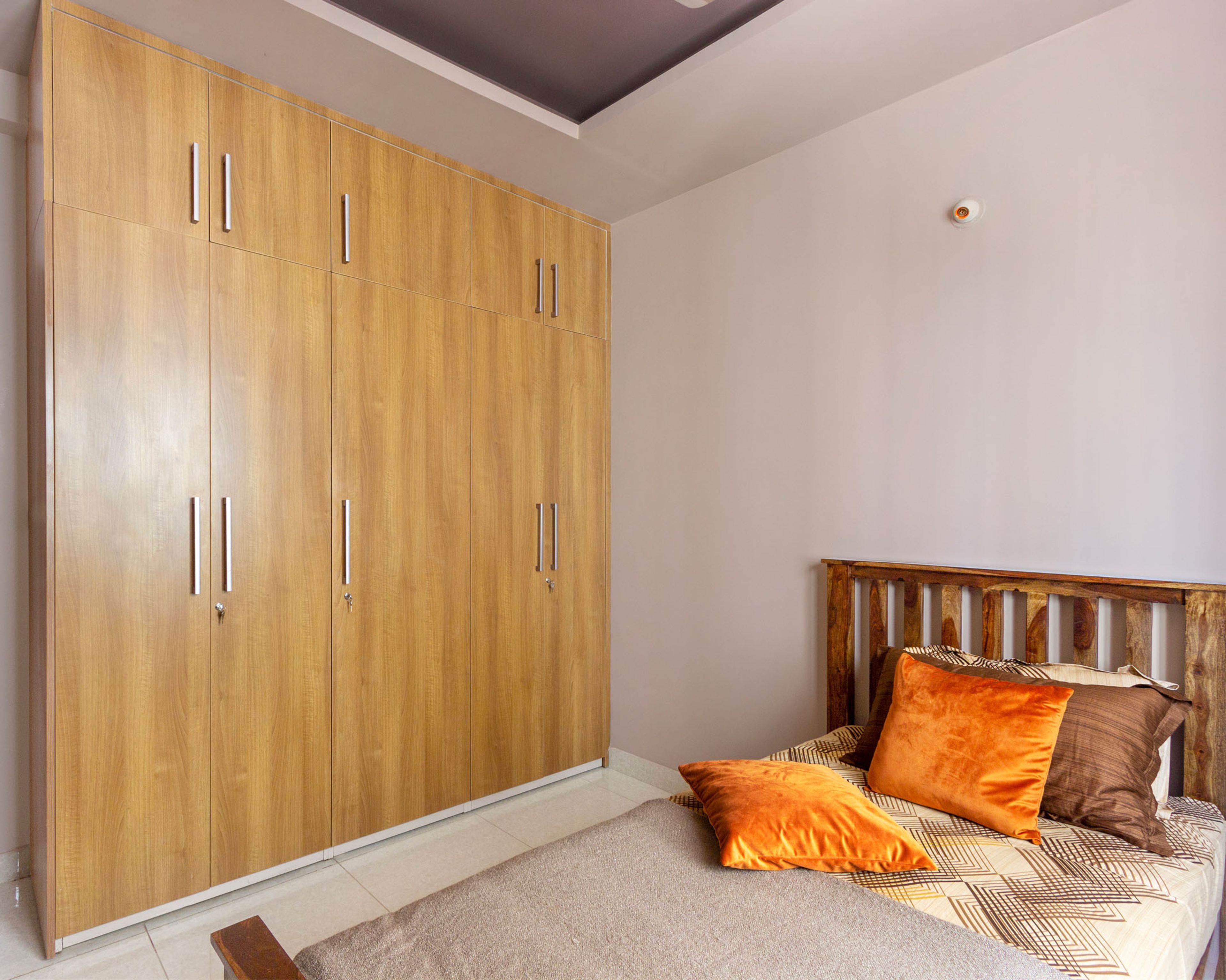 Guest Room With 5-Door Swing Wooden Wardrobe With Loft Storage - Livspace