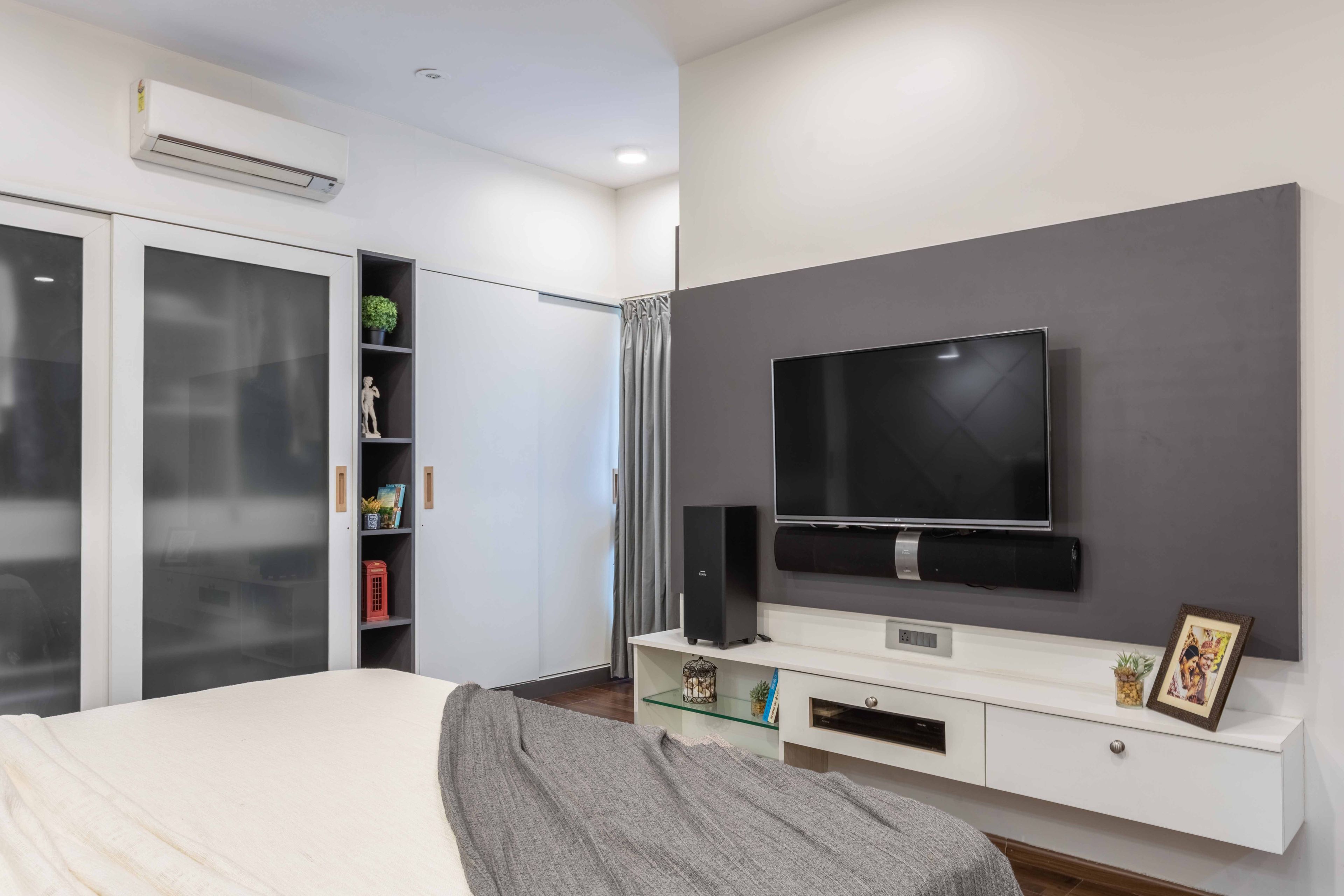 Grey And White Wall-Mounted TV Unit In The Master Bedroom - Livspace