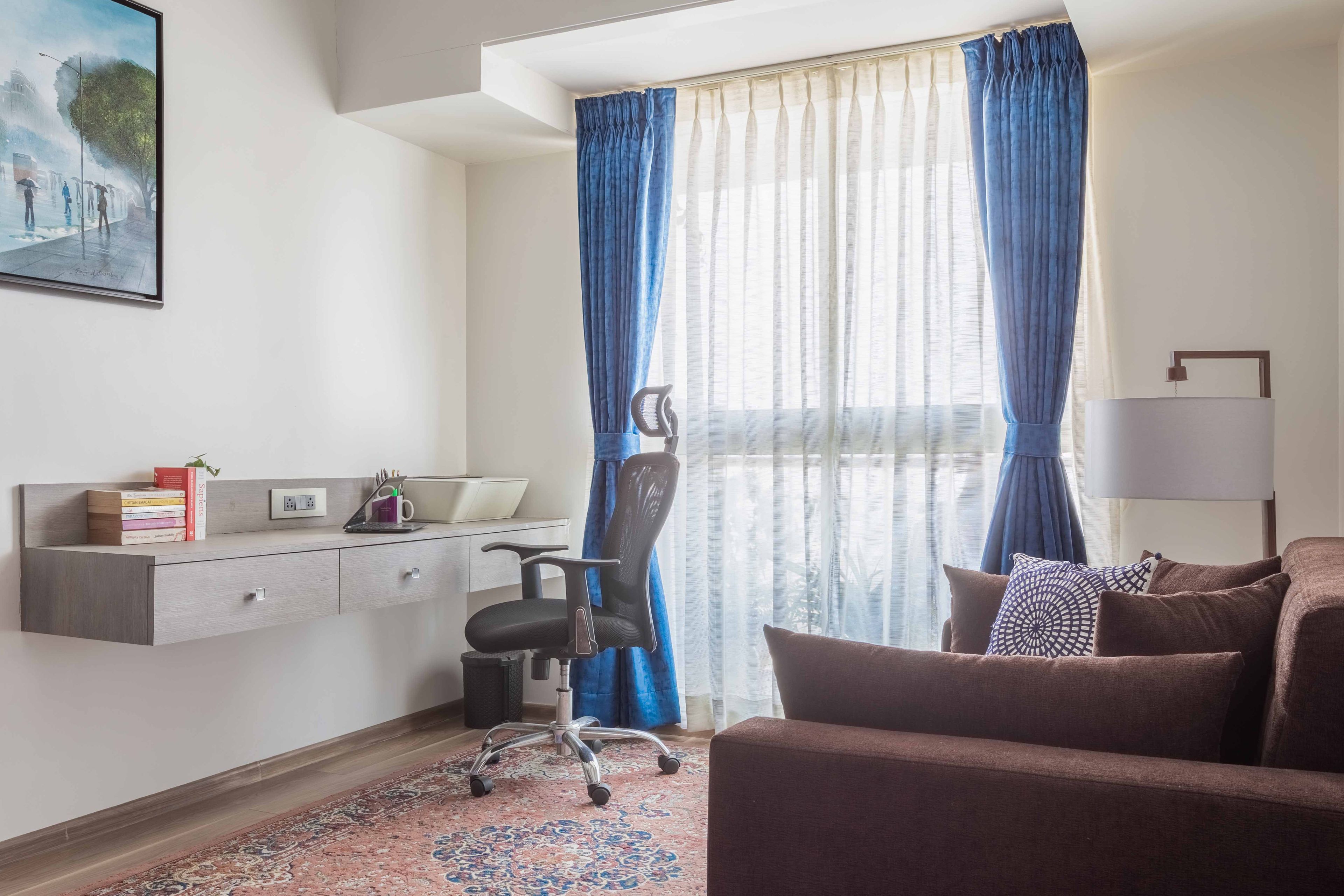 Home Office Design With Brown Sofa And Wall-Mounted Light Wood Study Table - Livspace