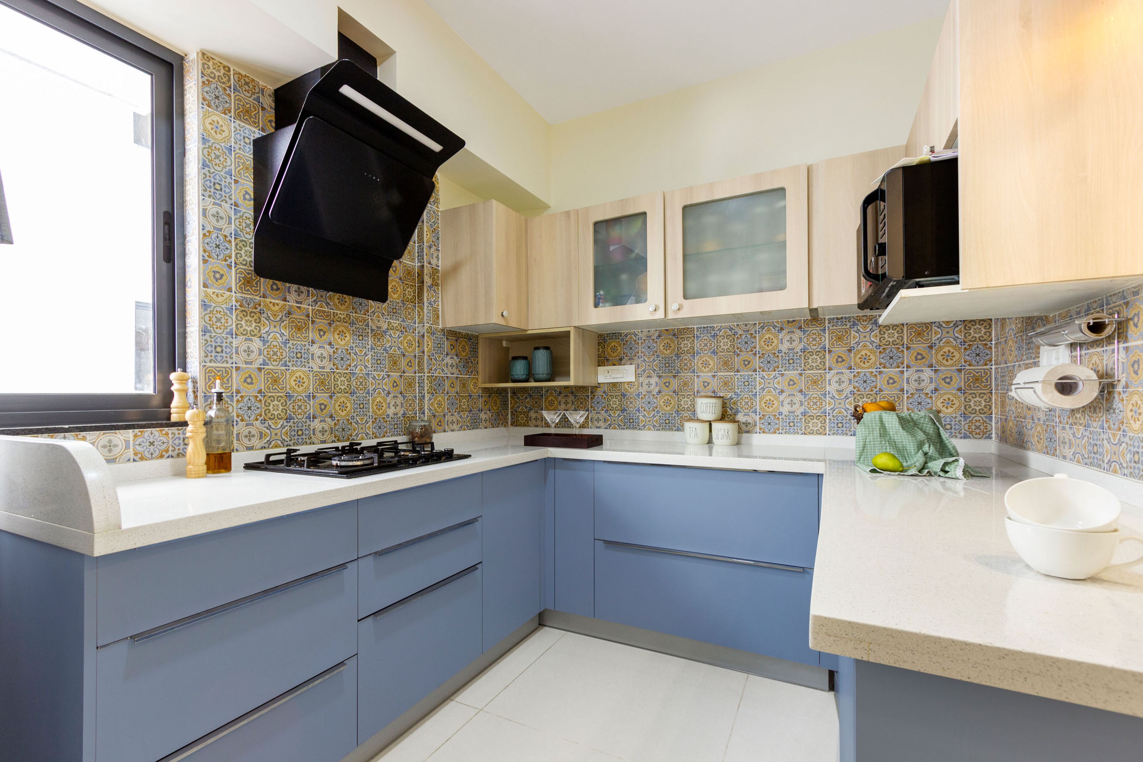 Modern 2-BHK Flat Design In Bangalore With U-Shaped Blue And Light Wood Modular Kitchen