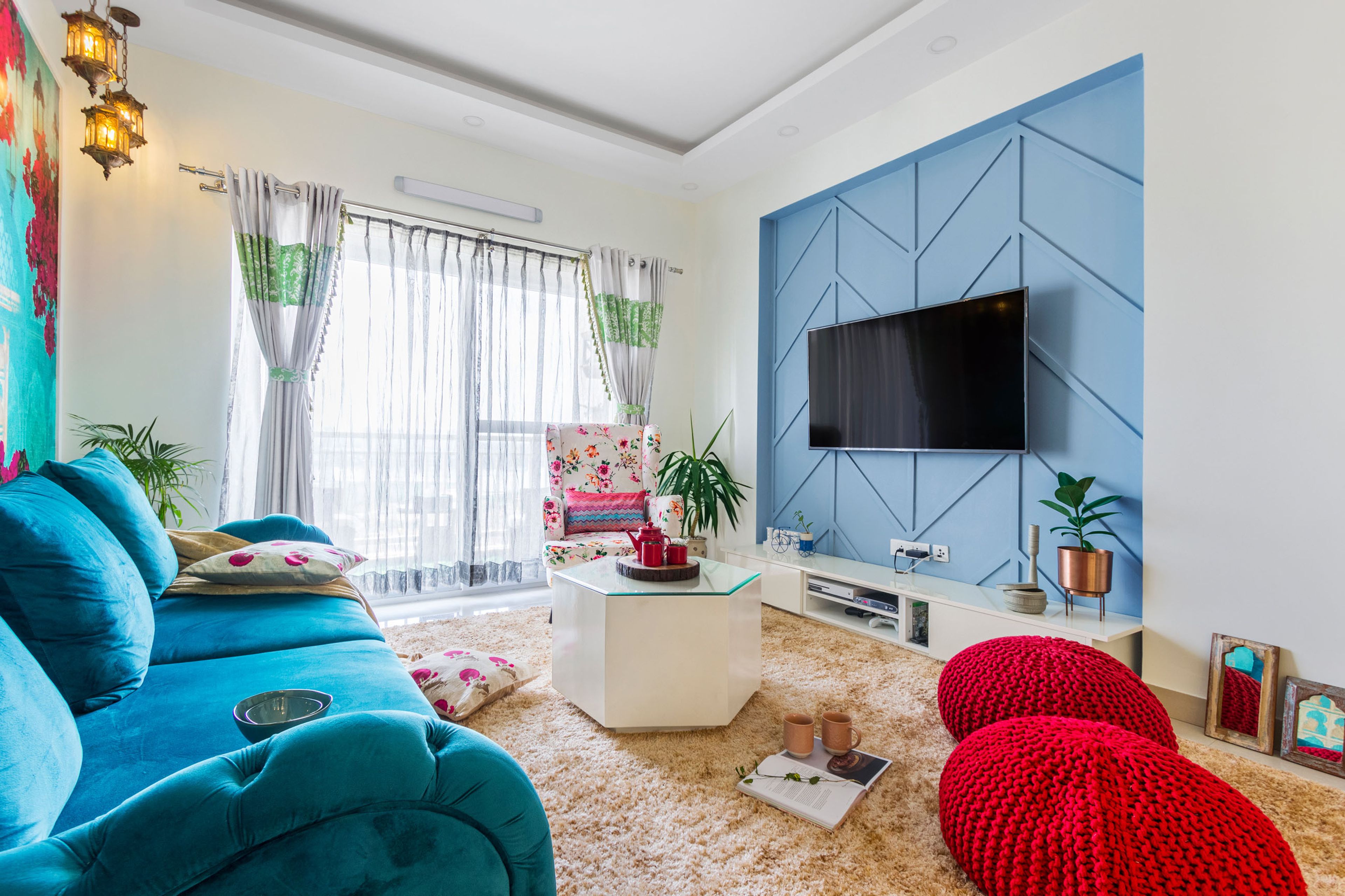 Contemporary 2-BHK Flat Design In Bangalore With Blue And Pink Living Room Design And Bougainvillea Wallpaper