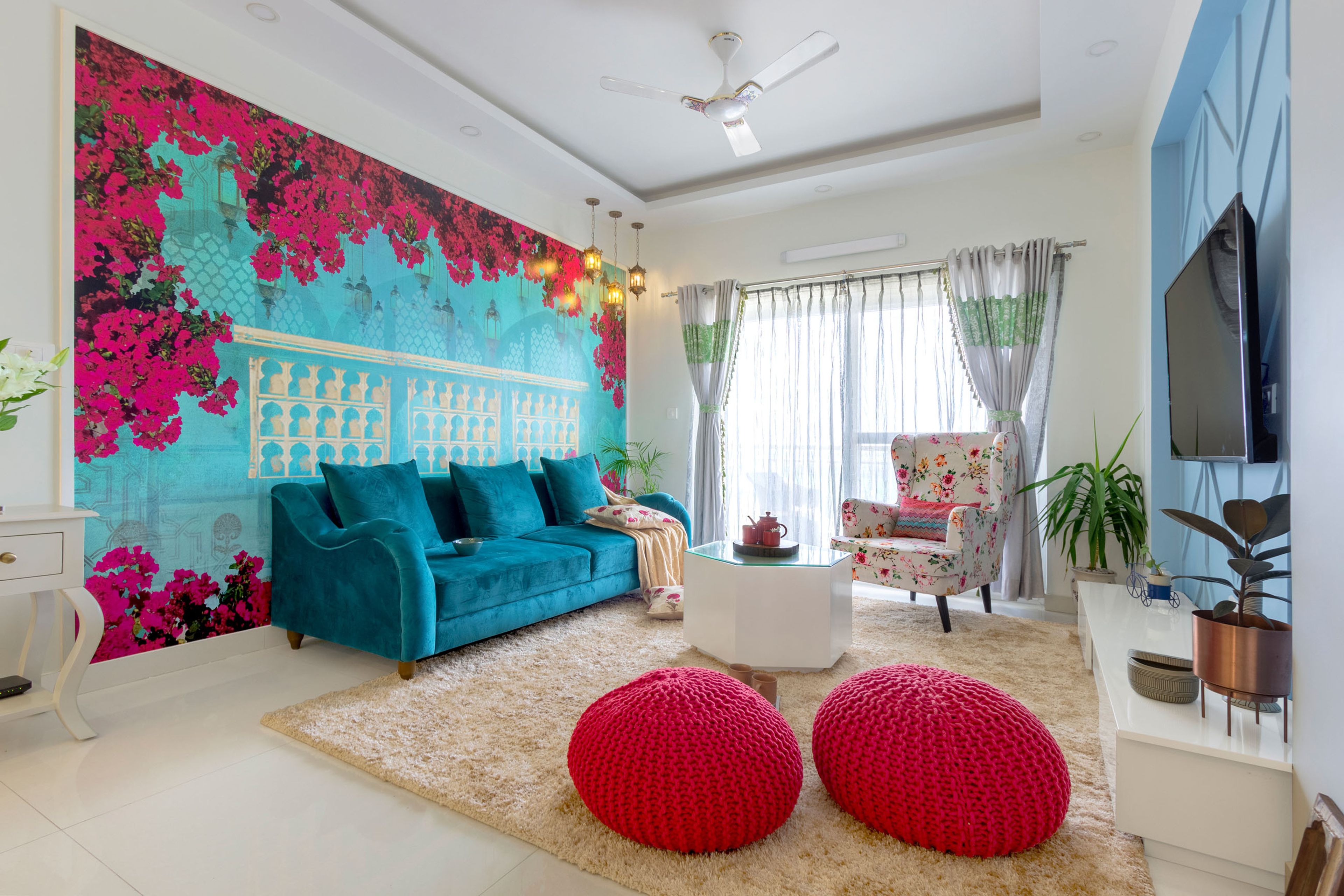 Spacious Living Room With Blue Sofa And Bougainvillea Blue And Pink Wallpaper Design - Livspace