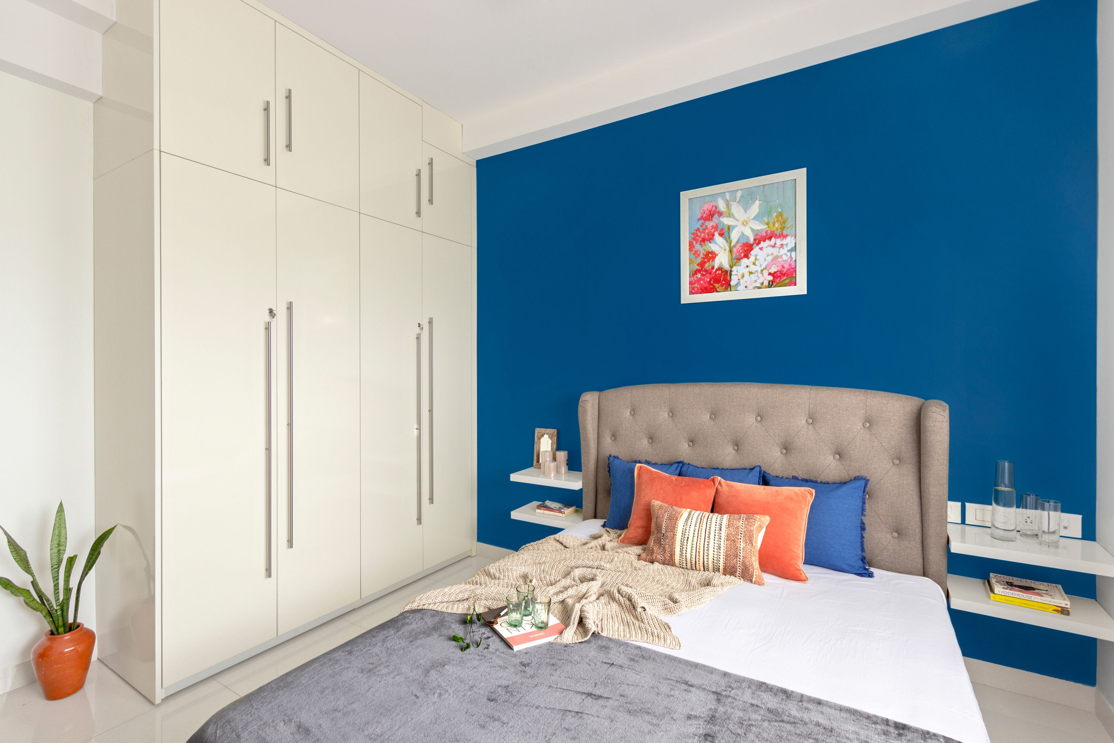 Blue Guest Bedroom With Off-White 4-Door Swing Wardrobe With Loft Storage - Livspace