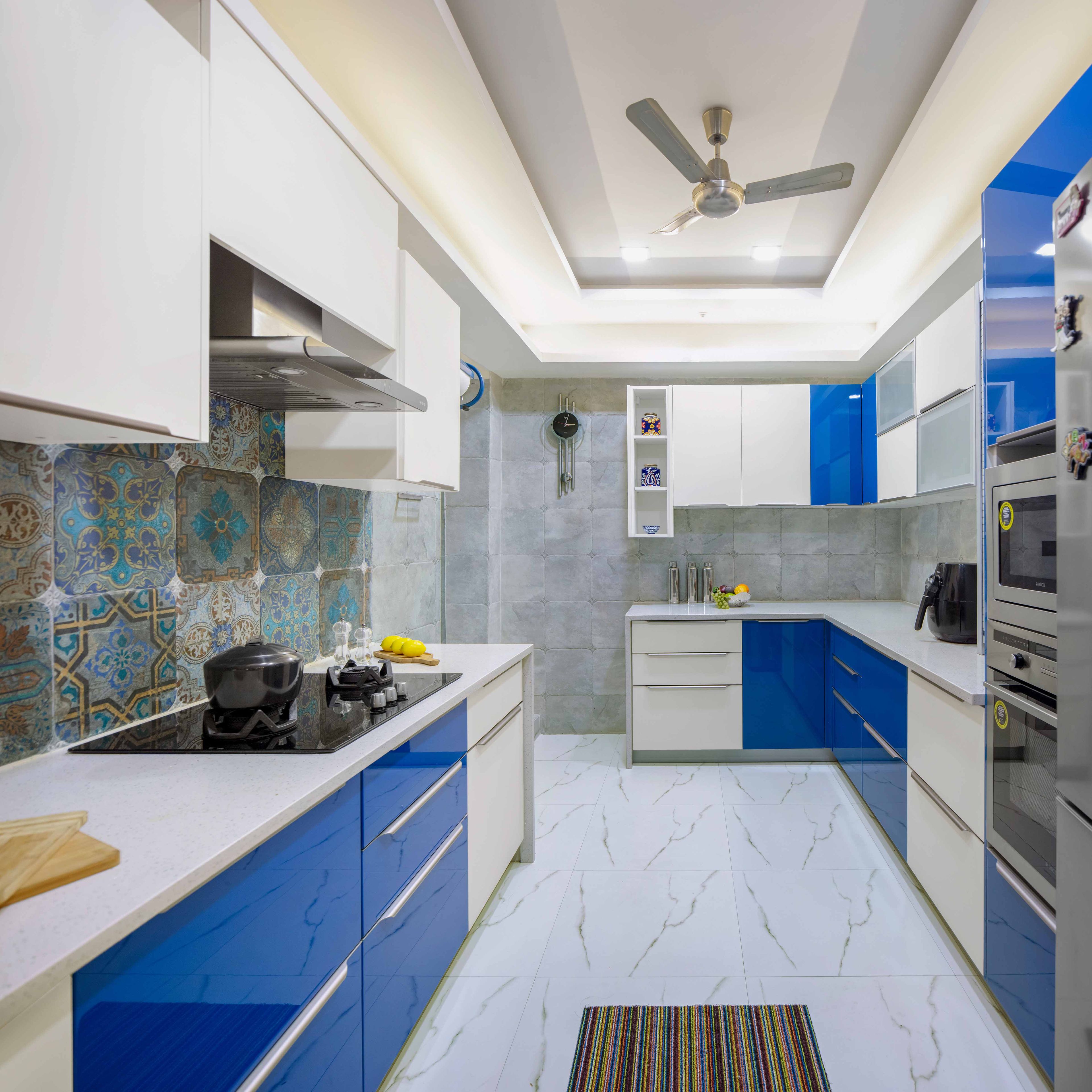 Parallel white and blue modular kitchen design with false ceiling - Livspace