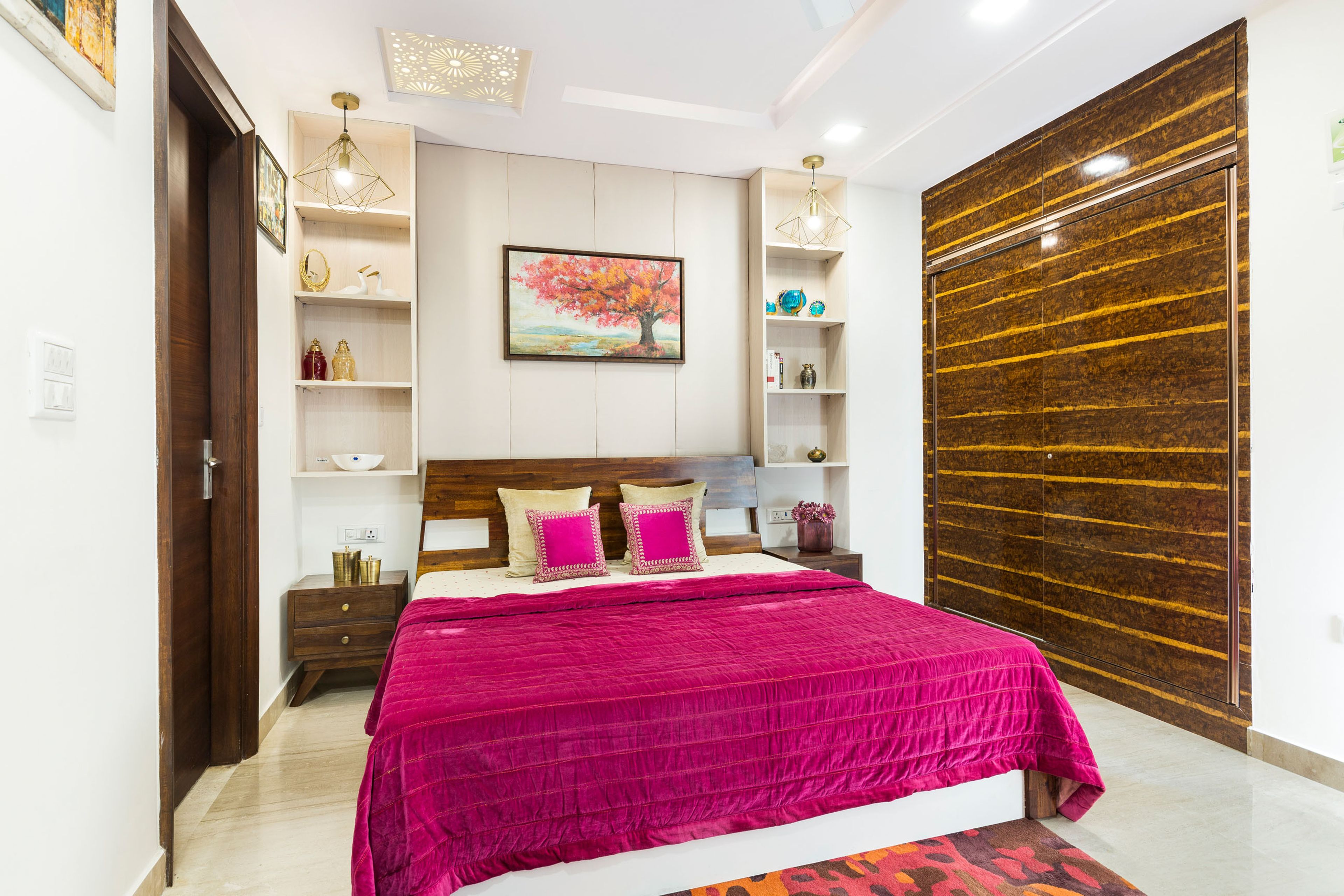 Guest Bedroom With PInk Bed, Wooden 2-Door Sliding Wardrobe And Open White Wall Storage - Livspace