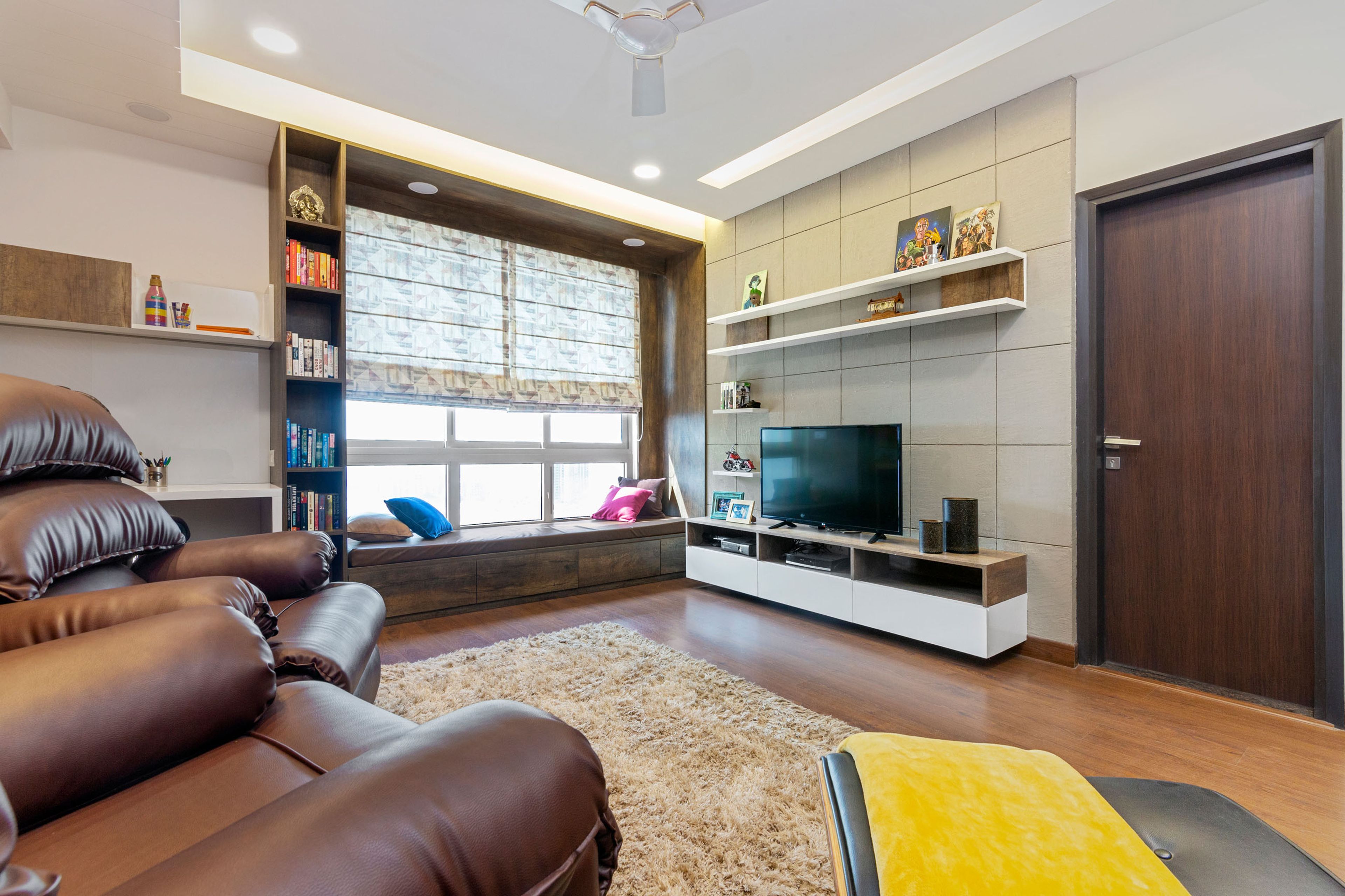 Family Room With Square-Panelled Beige TV Unit - Livspace