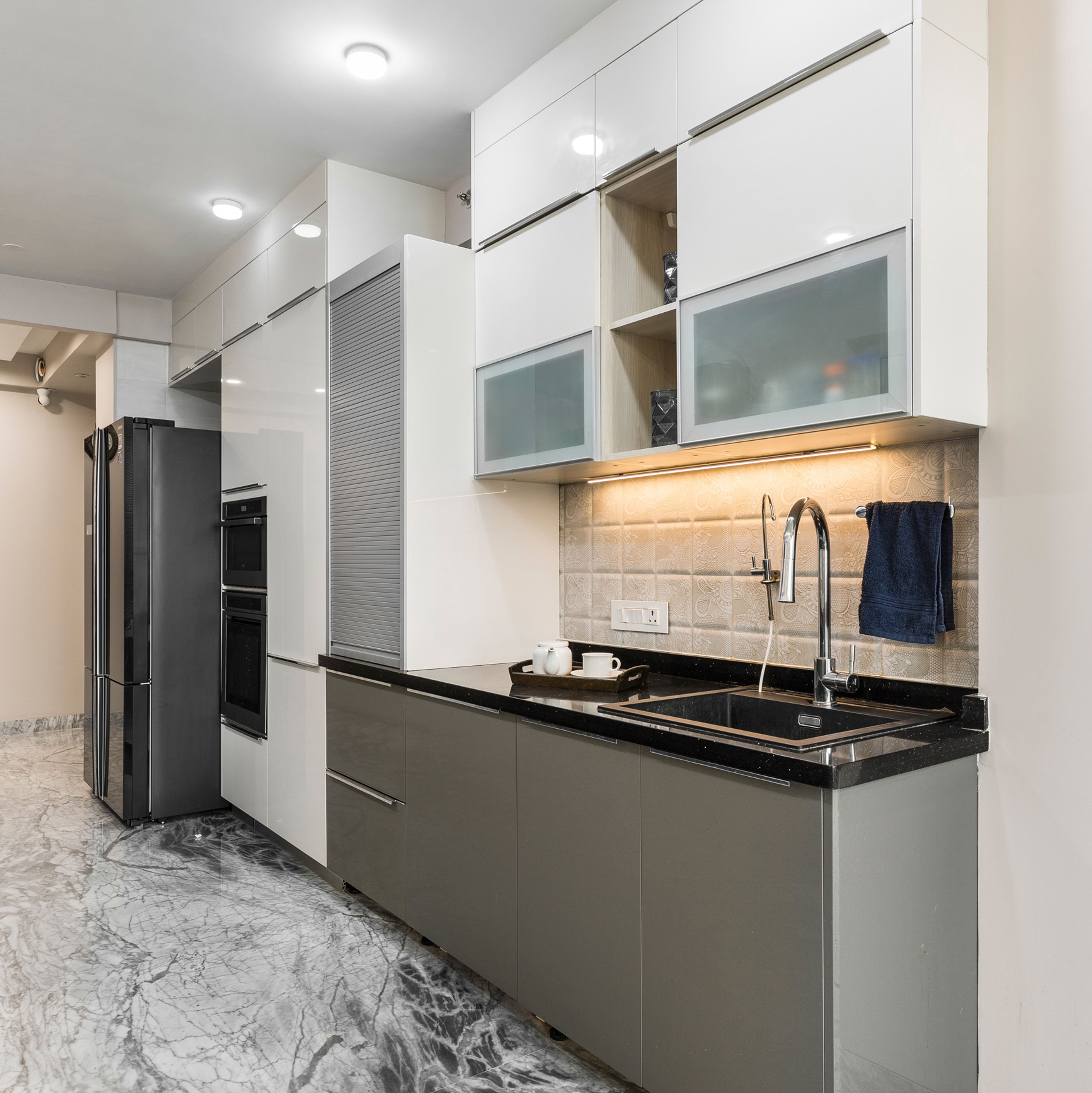 Grey And White Parallel Kitchen Design With Tall Appliance Unit - Livspace