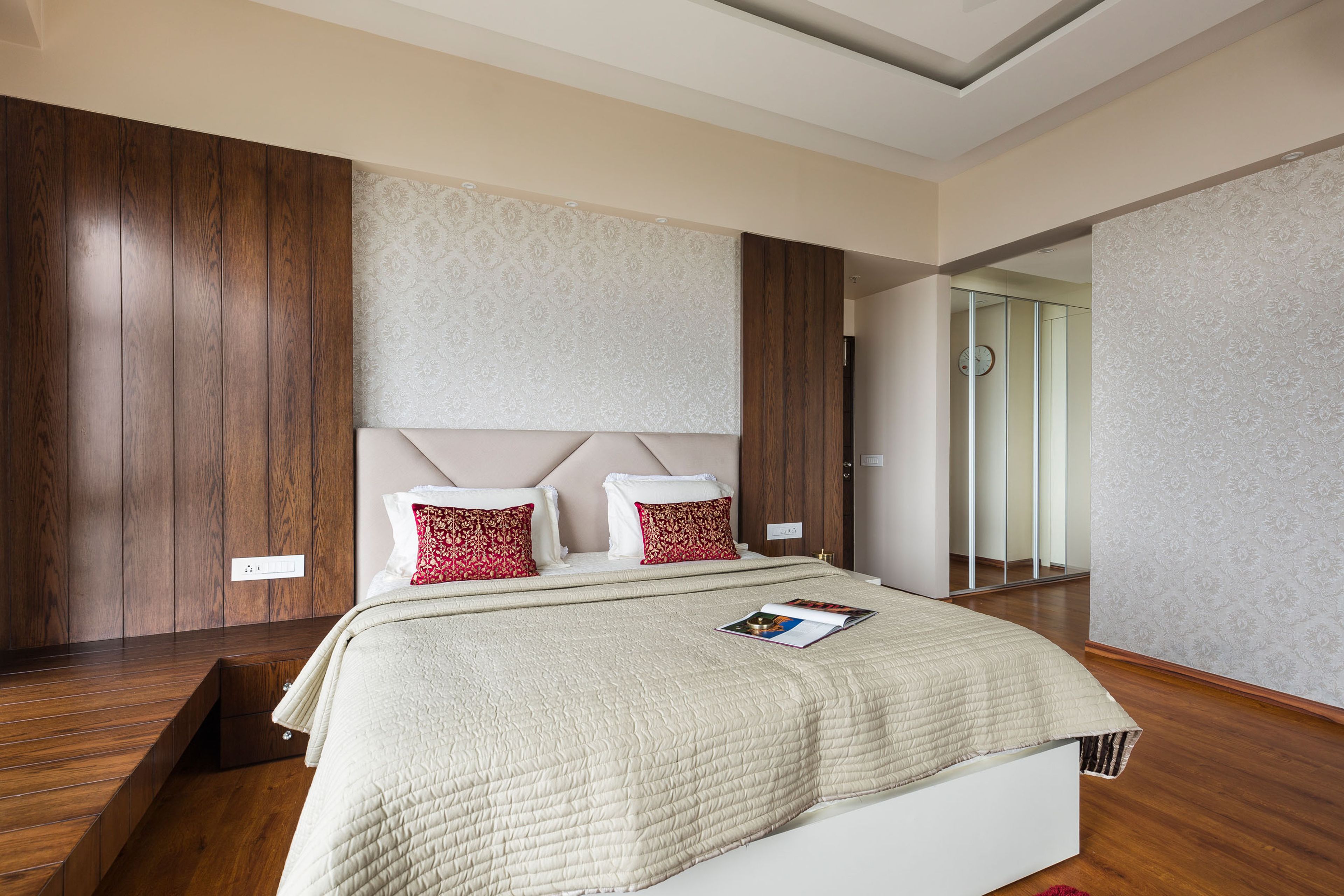 Master Bedroom With Beige Headboard, Wooden Panels And White Damask Wallpaper - Livspace