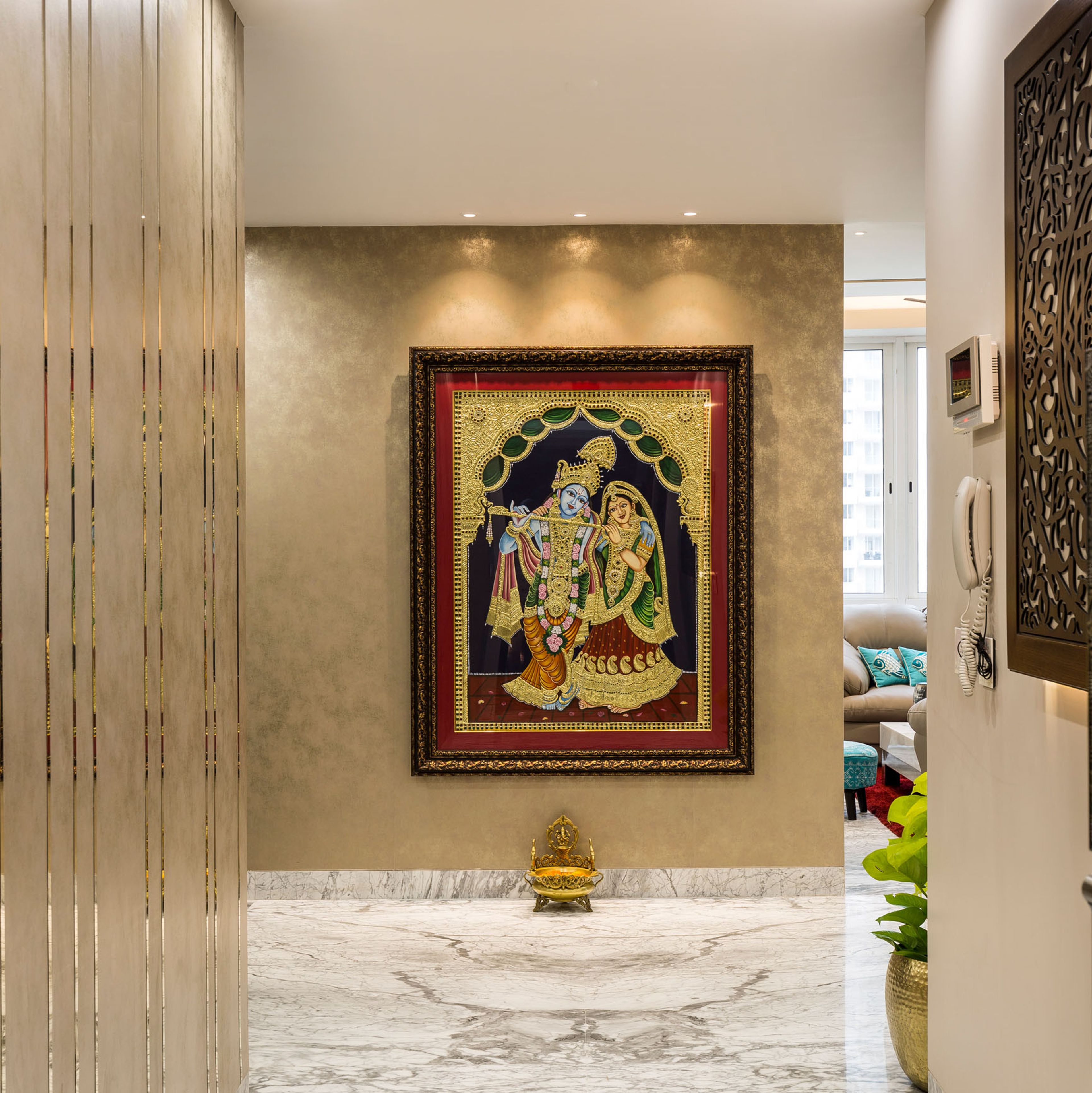 Foyer Design With Beige Patterned Wall And Radha-Krishna Wall Art - Livspace