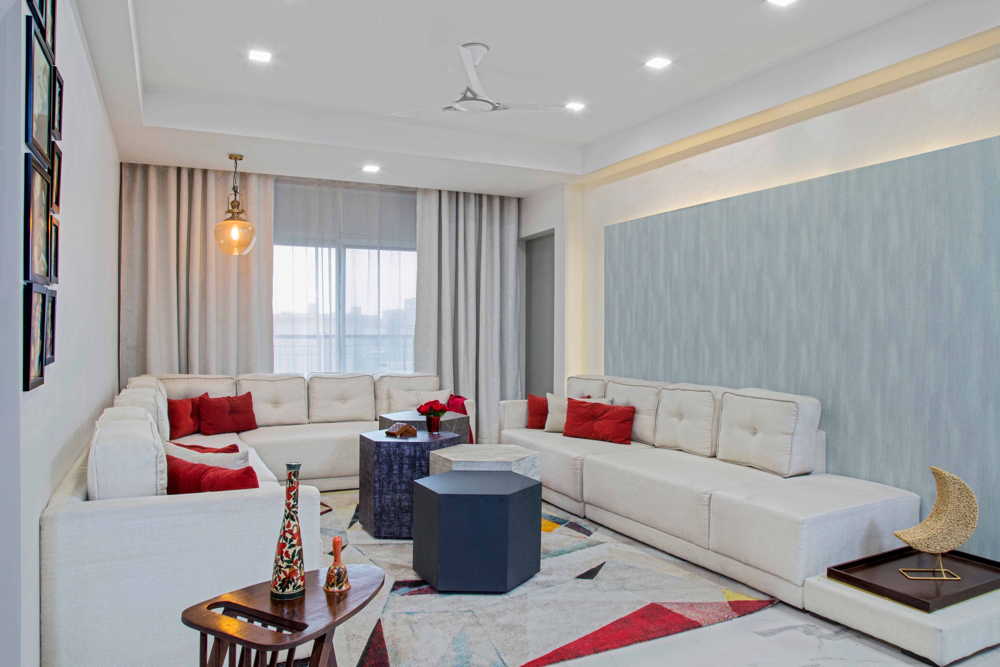 Modern 3 BHK Interior Design For Noida Flat With U-Shaped White And Red Living Room