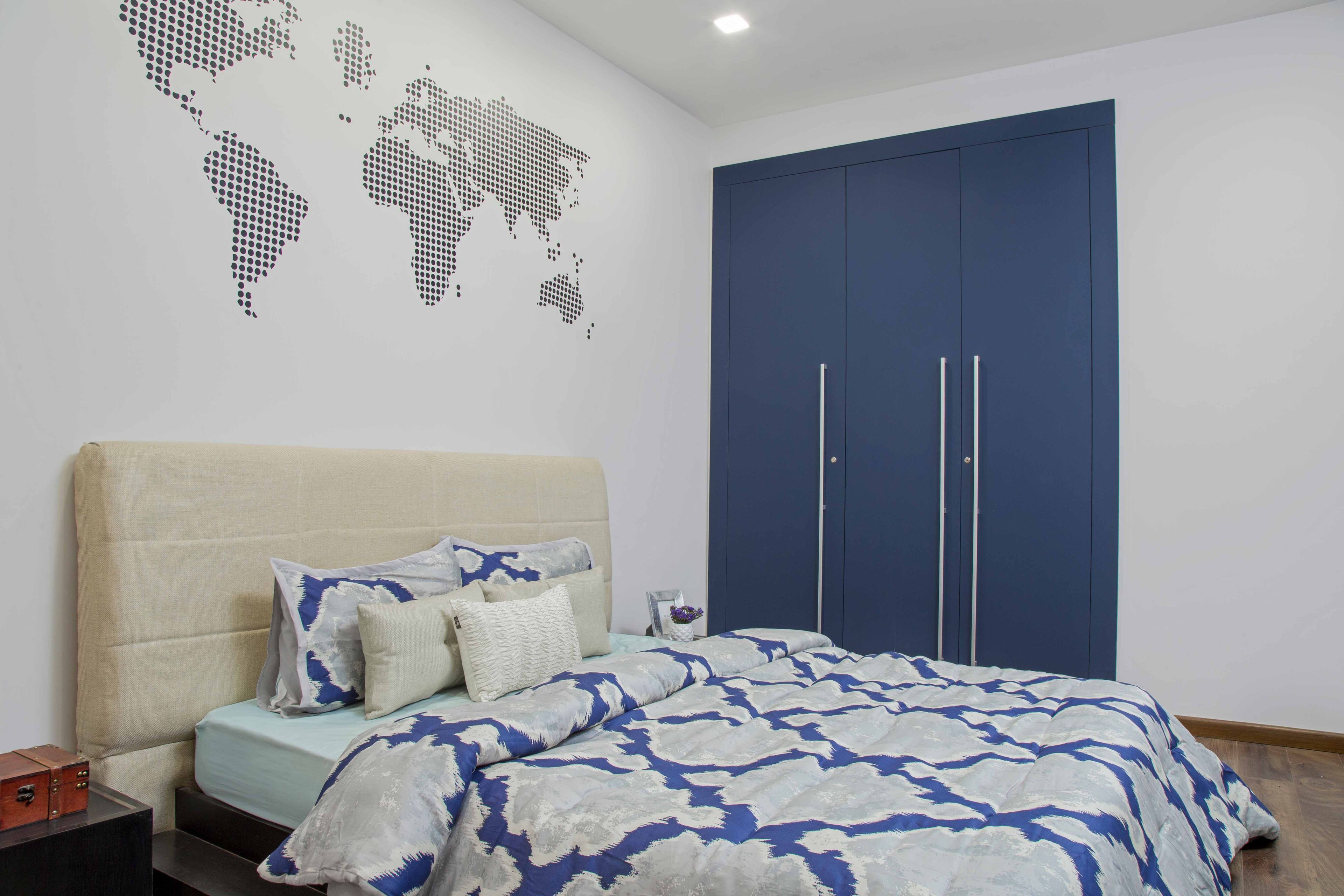 Master Bedroom With Cream-Toned Bed, World Map Wall Art And 3-Door Blue Swing Wardrobe - Livspace