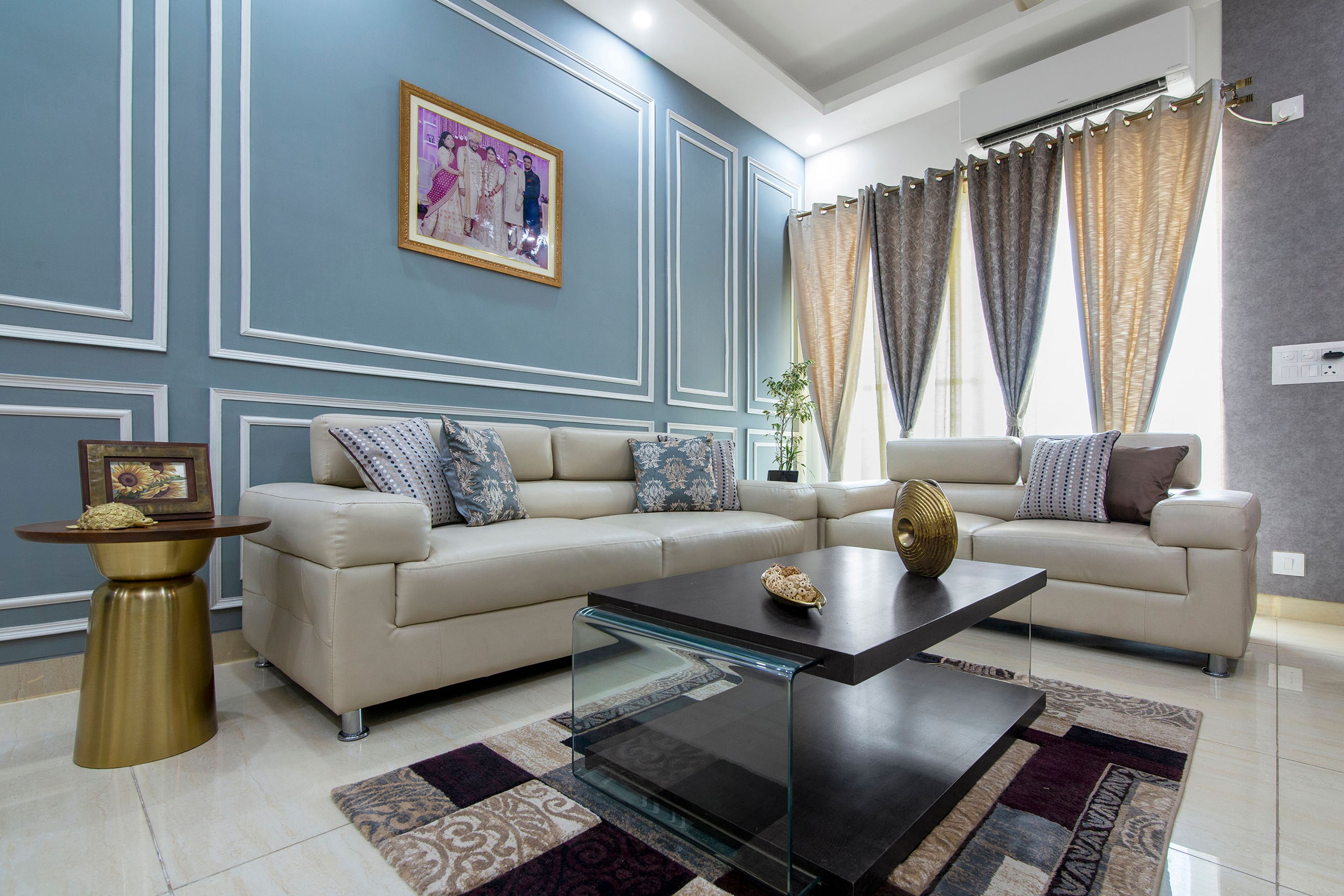 Blue And White L Shaped Living Room With Blue Accent Wall And White Trims - Livspace