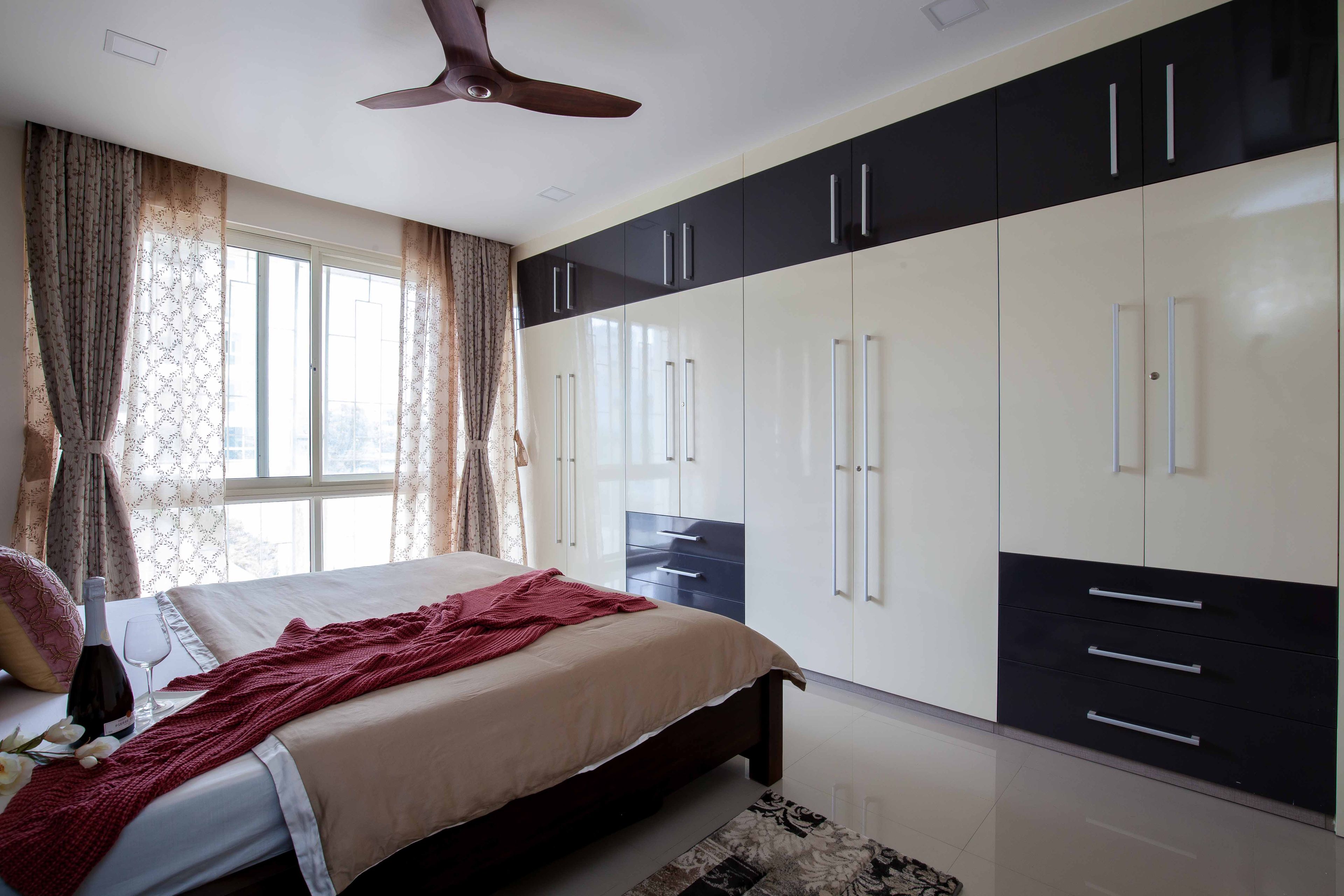Guest Bedroom With 8-Door Black And White Swing Wardrobe Design - Livspace