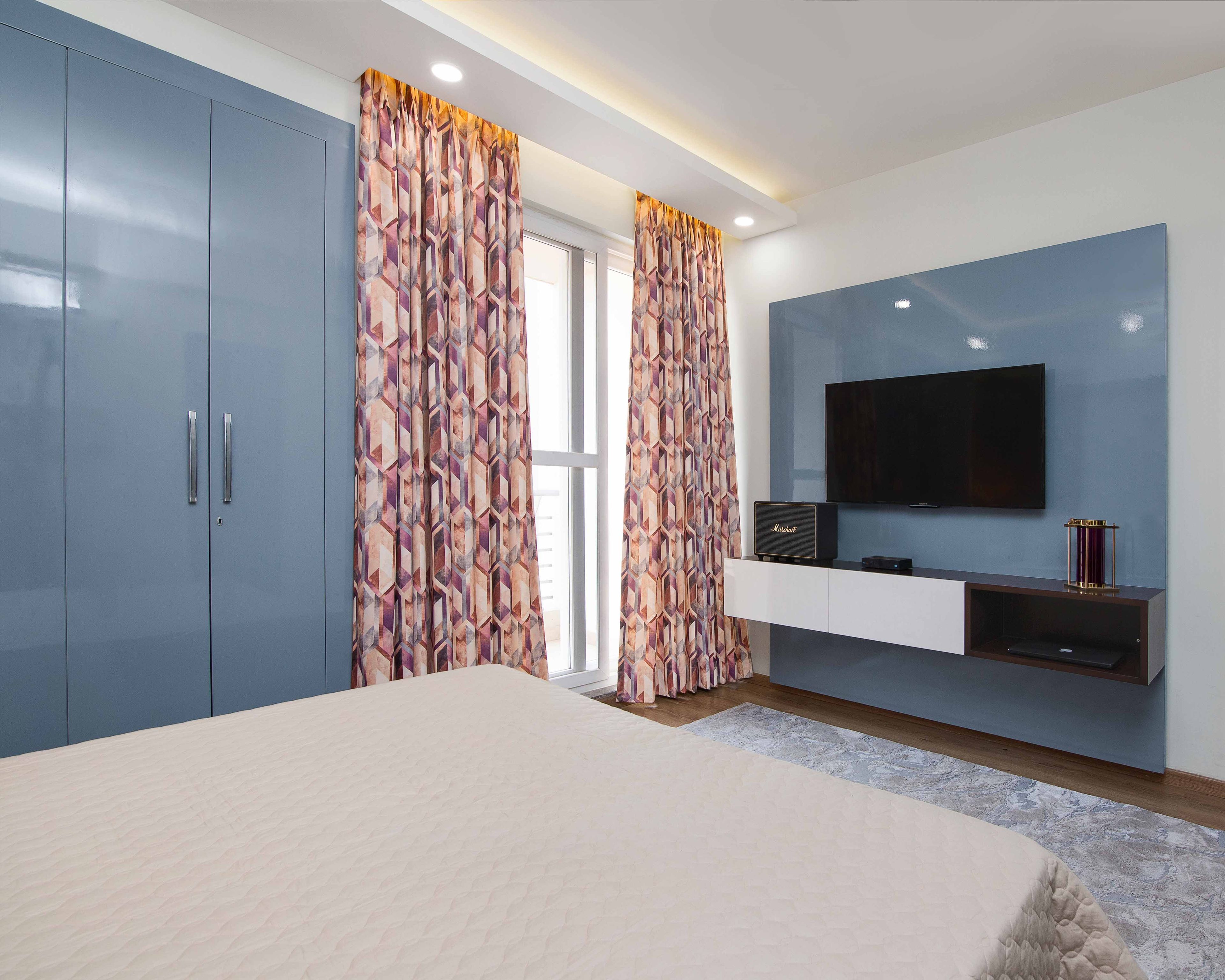 Wood And White Wall-Mounted TV Console WIth Blue Backdrop - Livspace