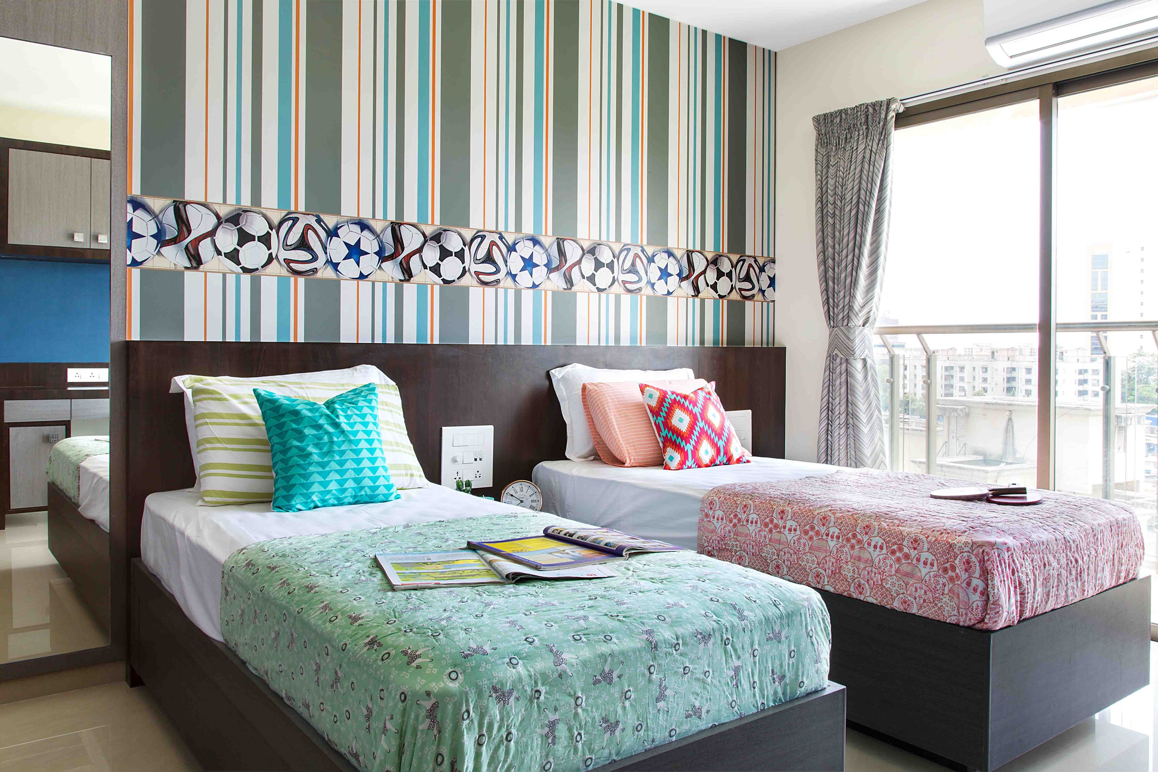 Bright Kids Bedroom With Two Single Beds, Striped And Football-Themed Wallpaper Design And Mirror - Livspace