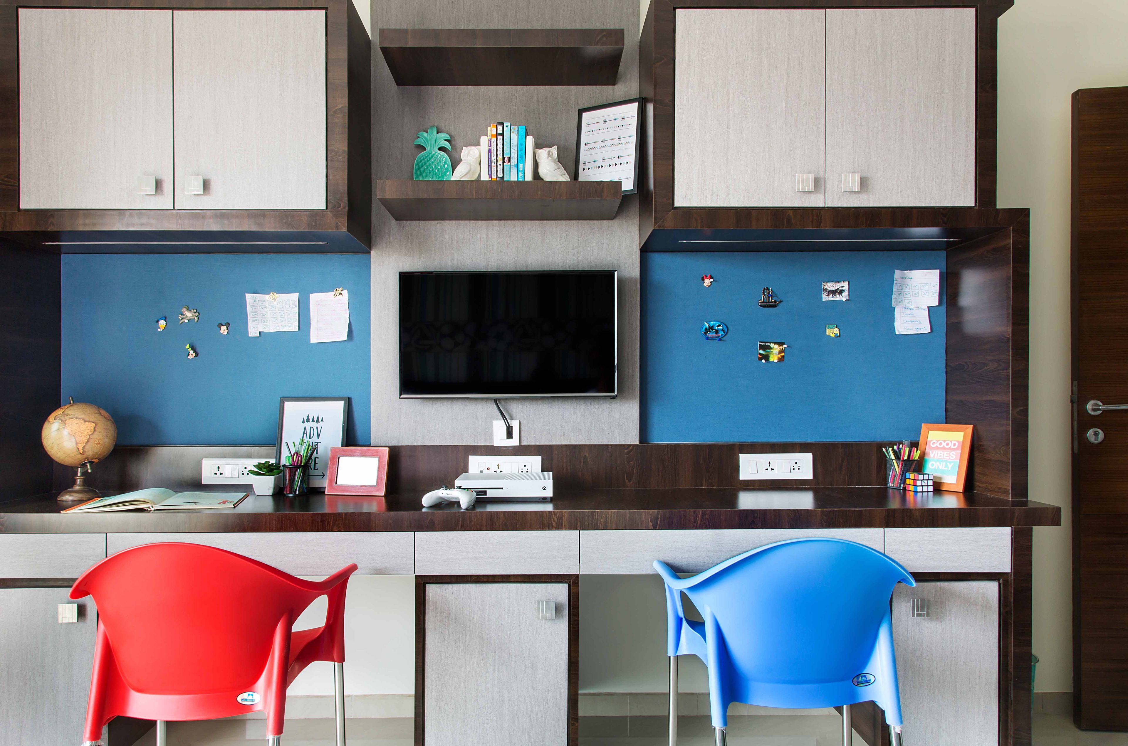 Dark Wood And Light Wood Study Table With Dual Study Units, Red And Blue Chairs - Livspace