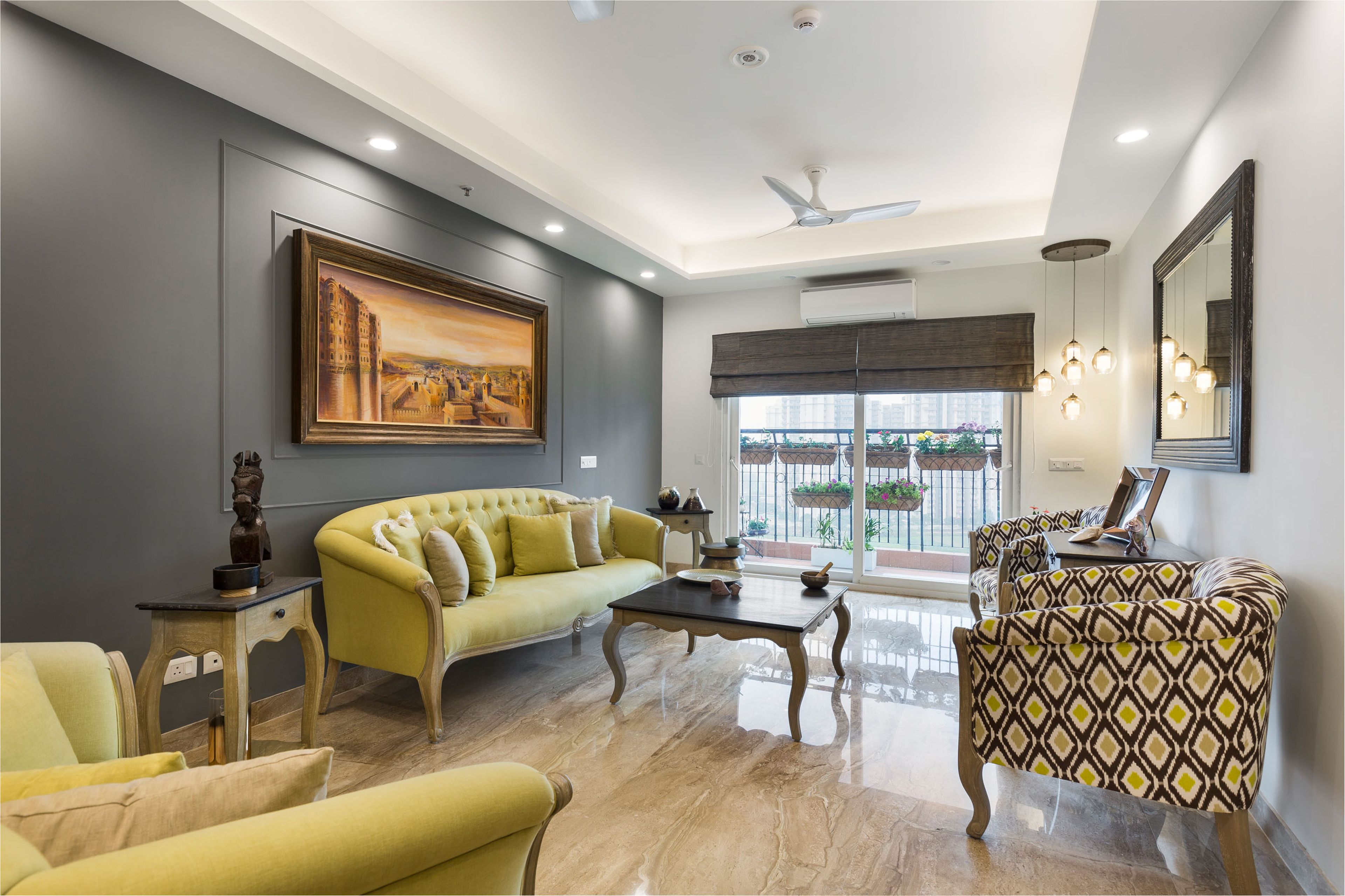 Spacious Living Room With Yellow Sofa, Patterned Accent Chairs And Grey Accent Wall - Livspace