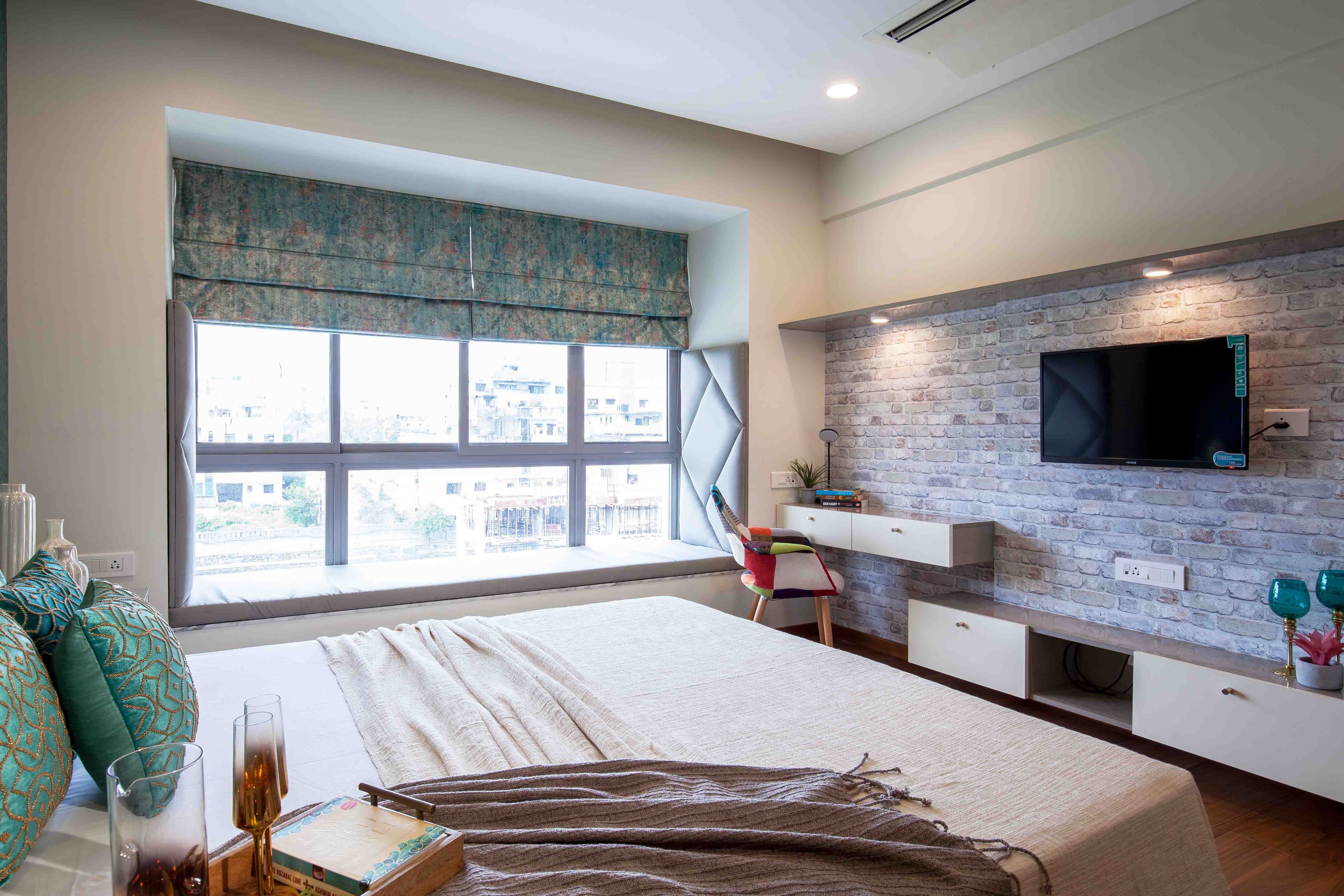 Master Bedroom With Wall-Mounted White TV Unit And Brick Wall - Livspace