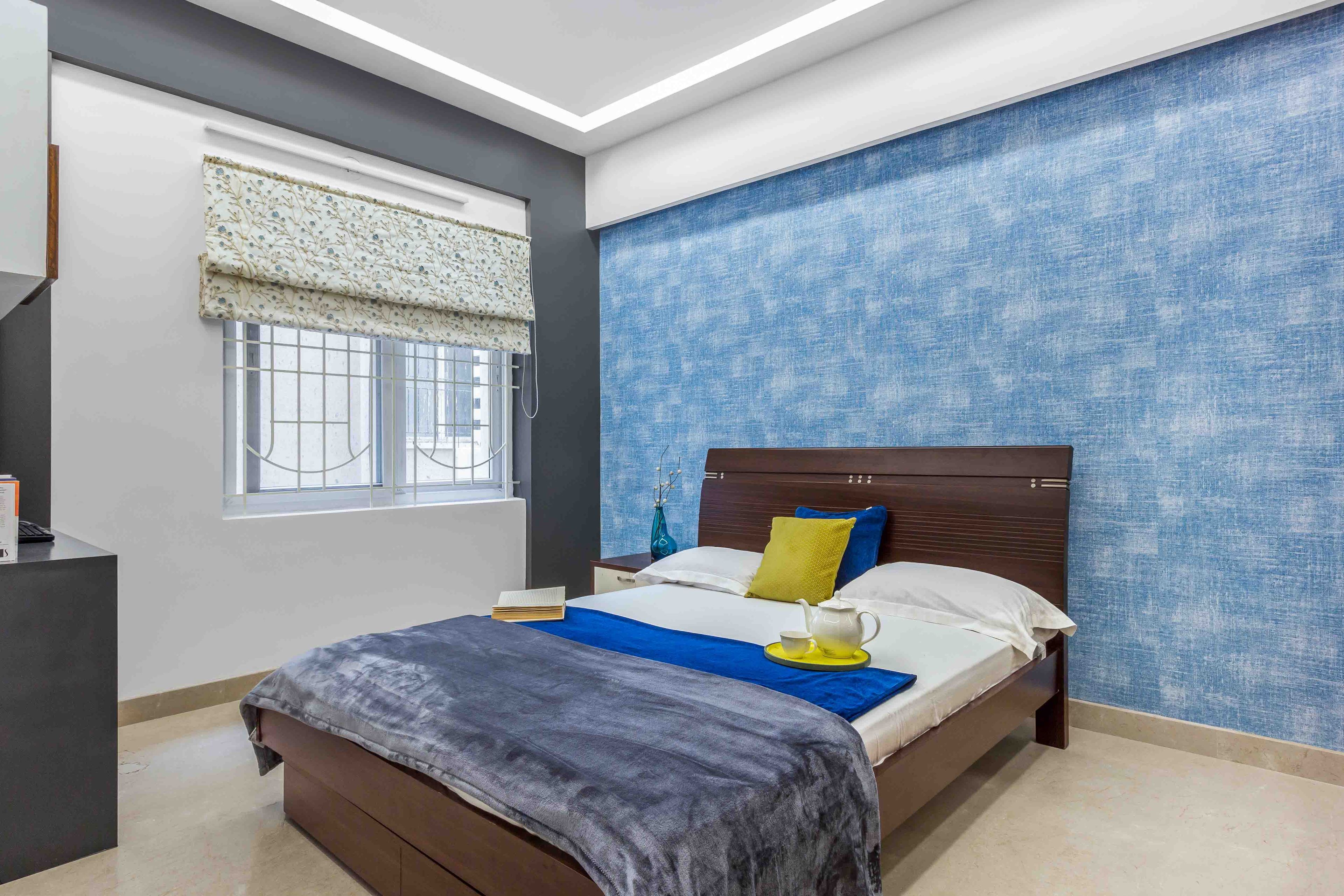 Guest Room With Blue Textured Wallpaper And Wooden Bed - Livspace