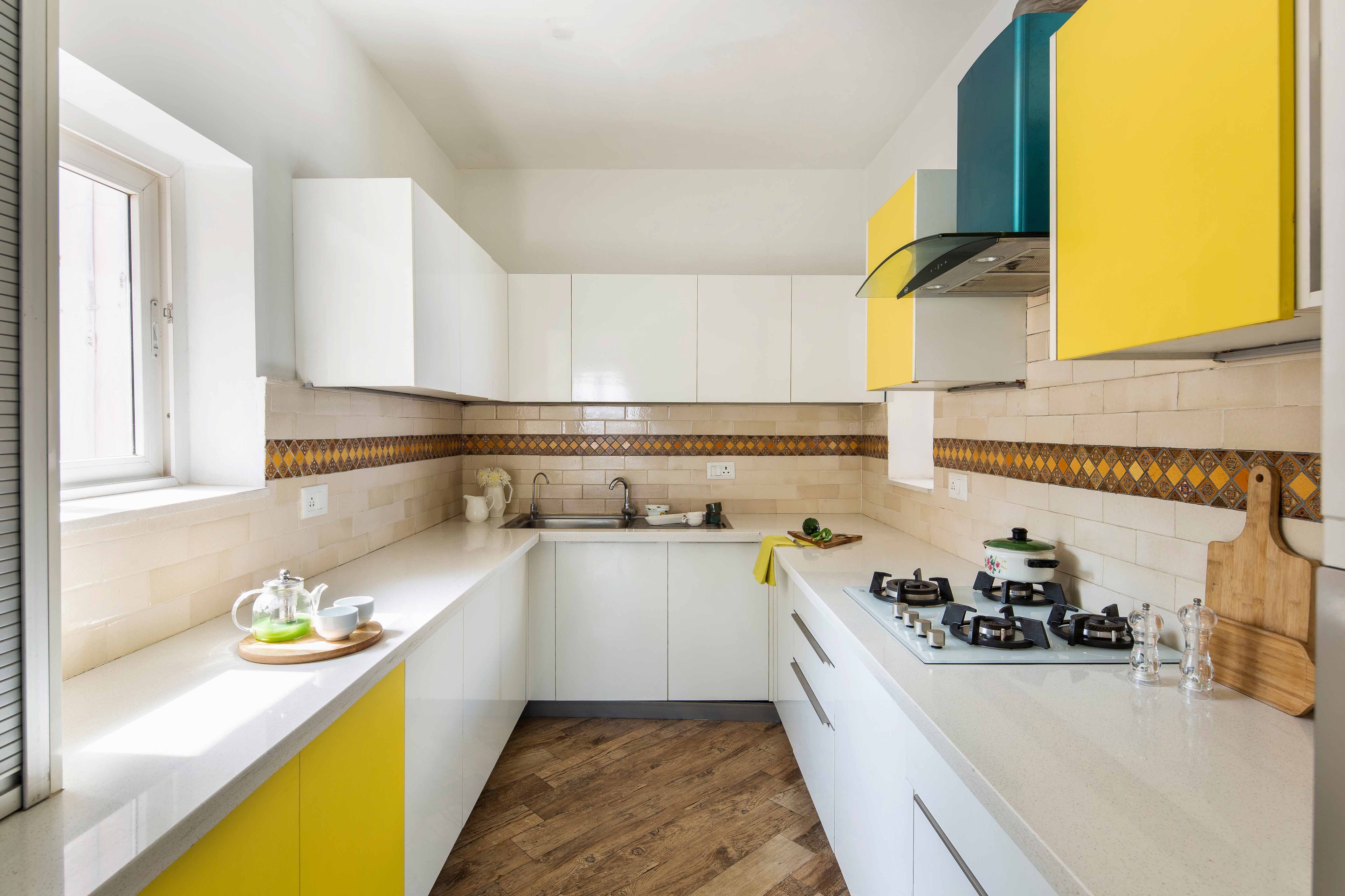White And Yellow U-Shaped Kitchen Design With Beige Subway Dado Tiles - Livspace