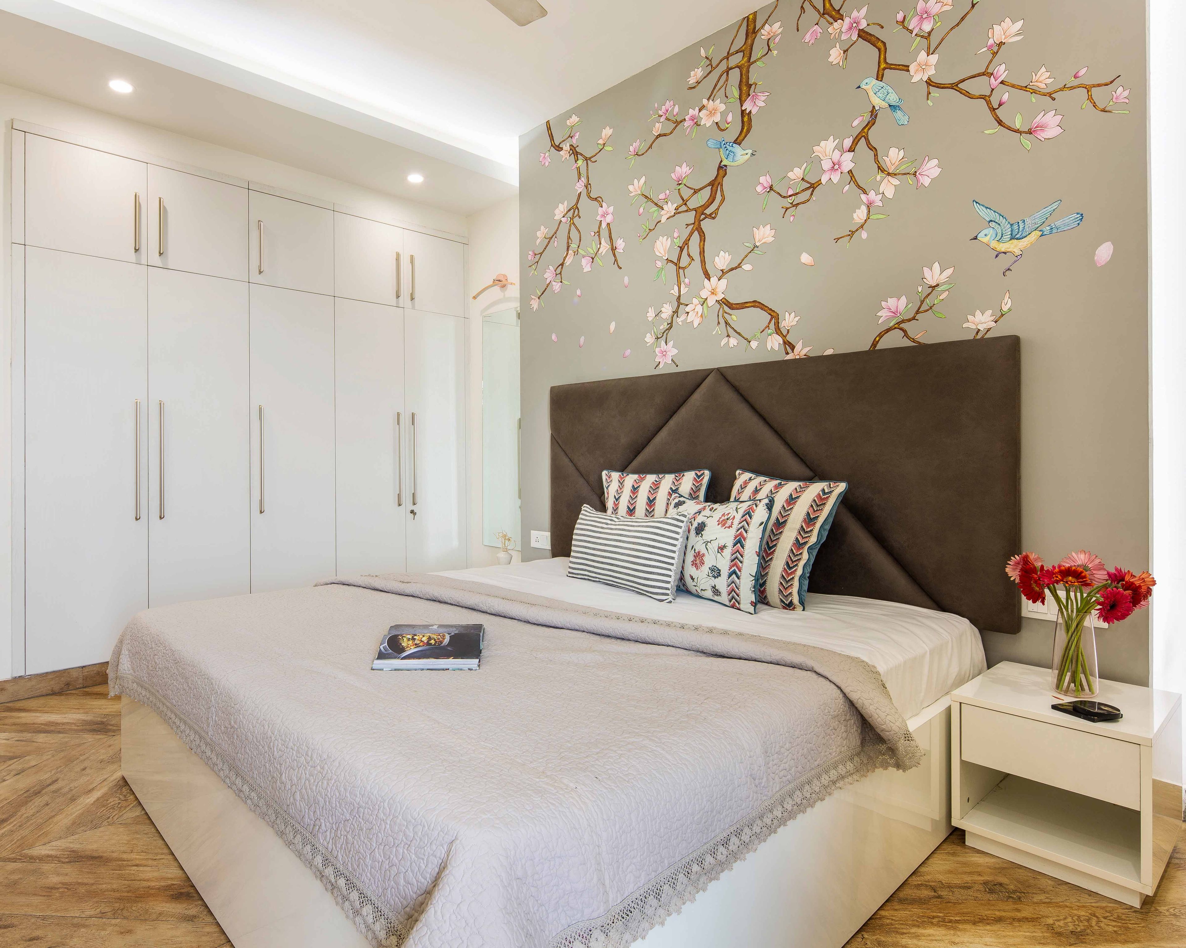 Master Bedroom With Brown Headboard, Nature-Themed Beige Wallpaper And 5-Door White Swing Wardrobe With Lofts - Livspace