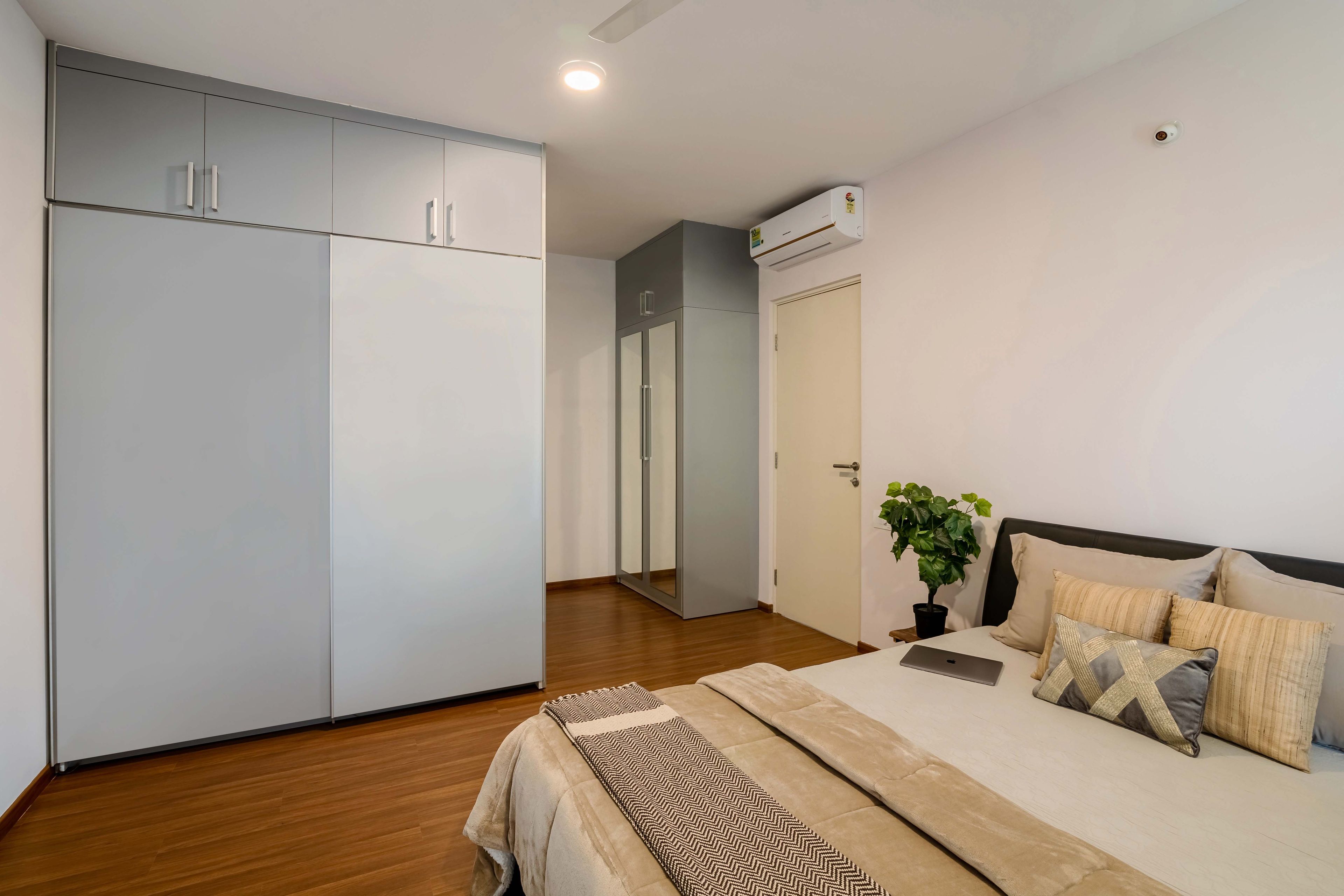 Master Bedroom With Grey And White Sliding Door With Lofts And Grey Mirrored 2-Door Swing Wardrobe - Livspace