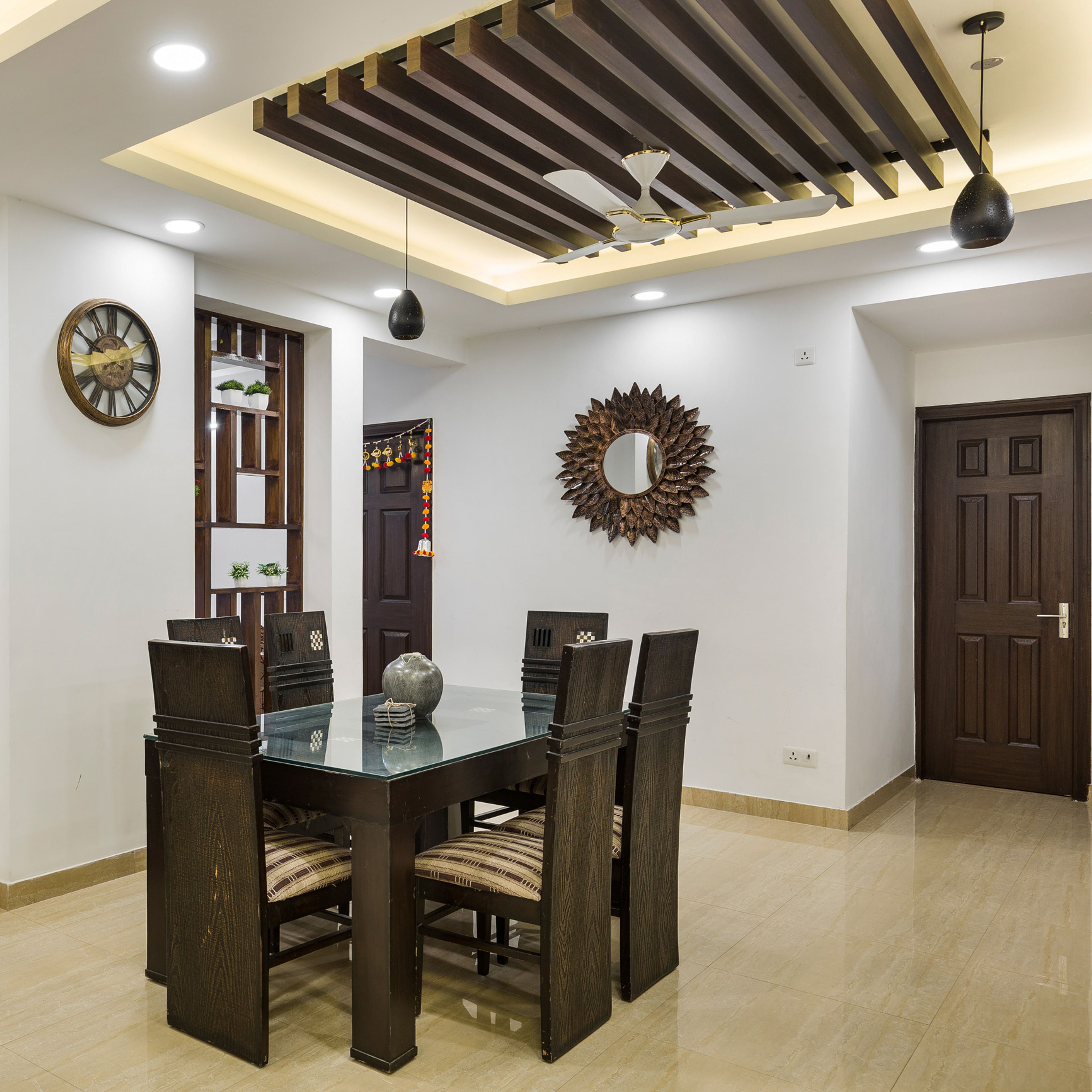 6-Seater Dark Wood Dining Room Design With Wood-Panelled False Ceiling - Livspace