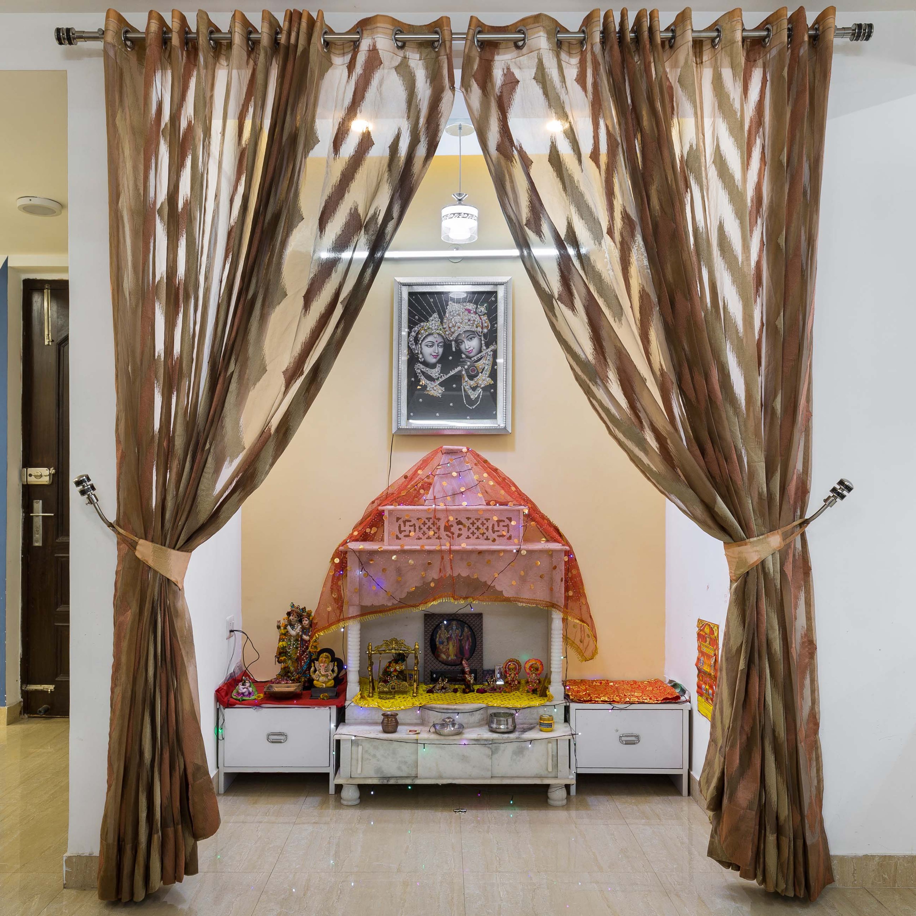 Floor-Mounted Pooja Room Design With Beige Wall And White Storage - Livspace