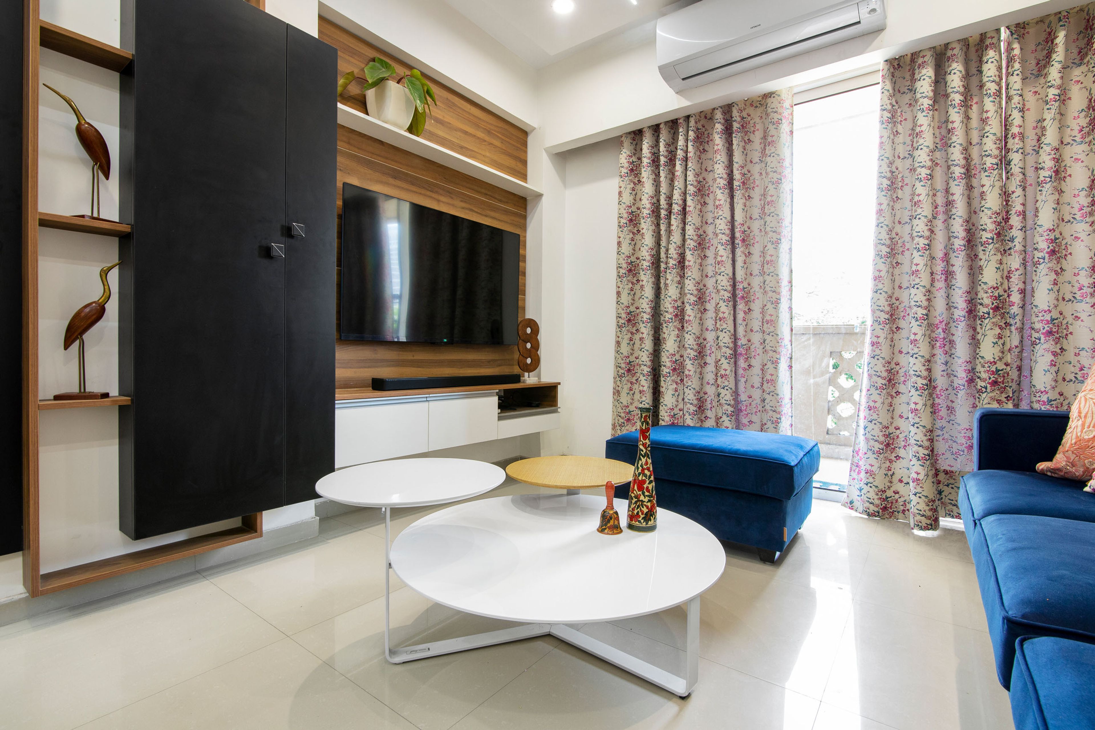 Living Room With 3-Seater Blue Sofa, Wood-White And Black TV Console And White And Wood Nesting Table - Livspace