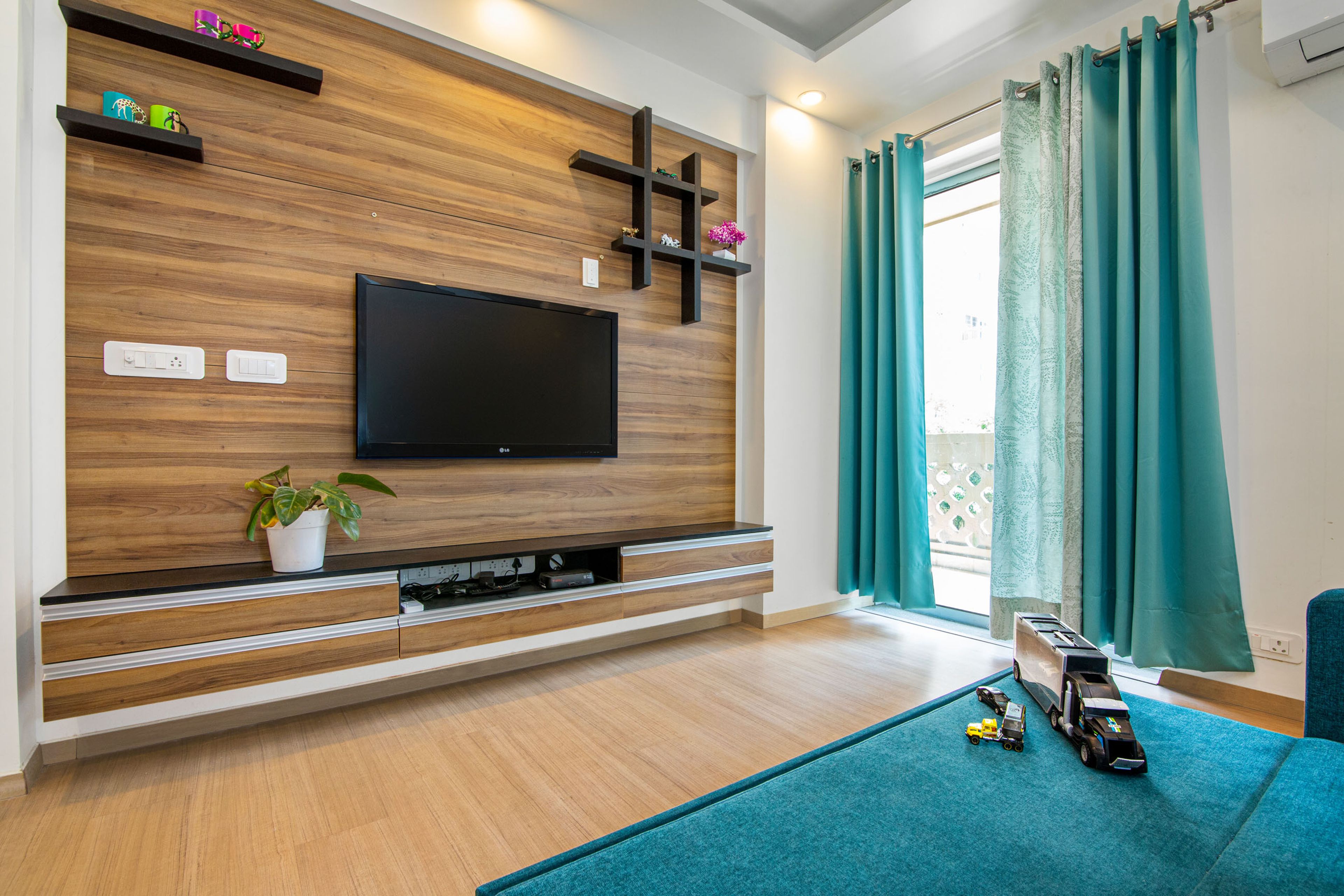 Kids Room With Wall-Mounted Wood And Black TV Unit - Livspace