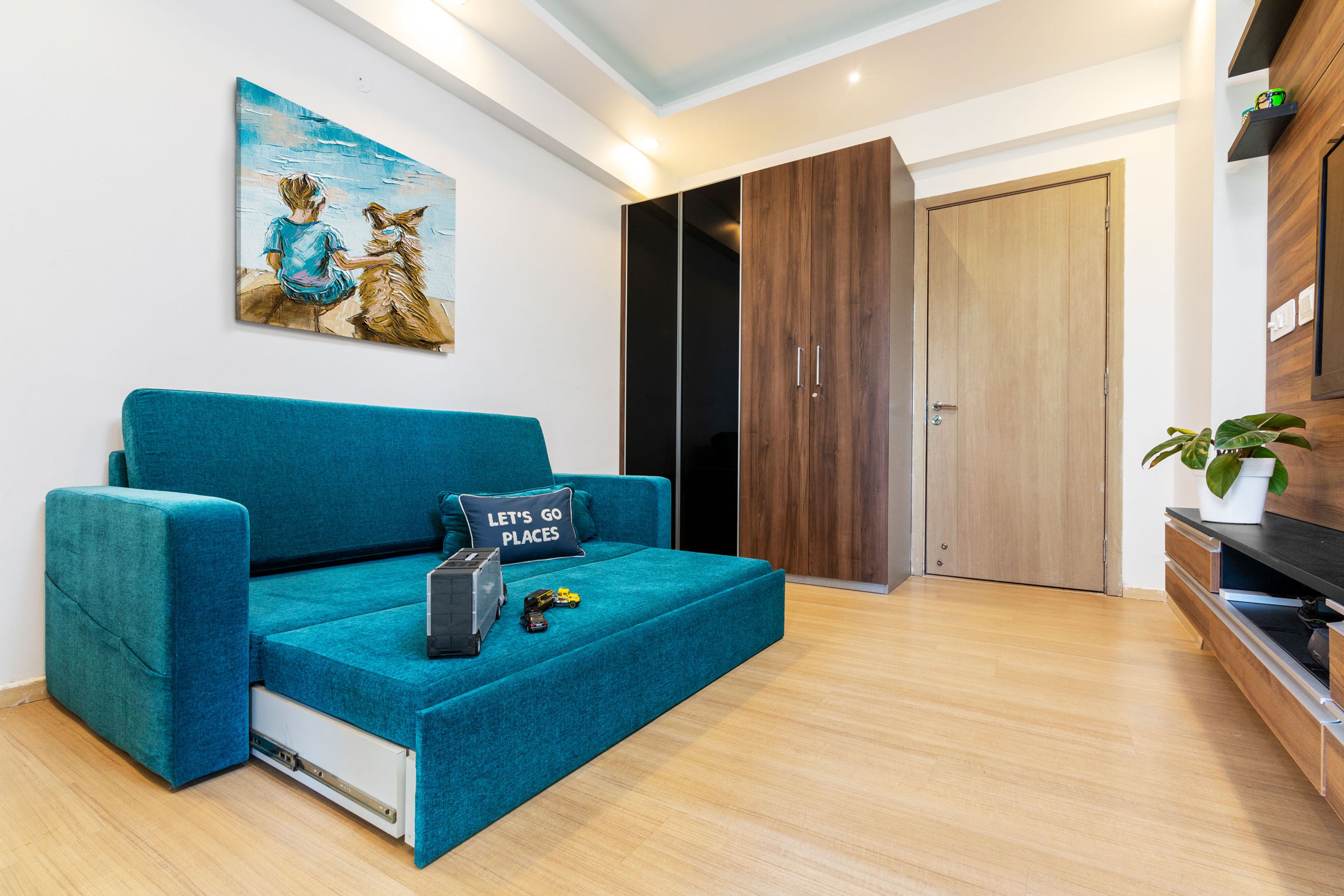 Kids Room With Blue Sofa-Cum-Bed And 4-Door Black And Wood Swing Wardrobe - Livspace