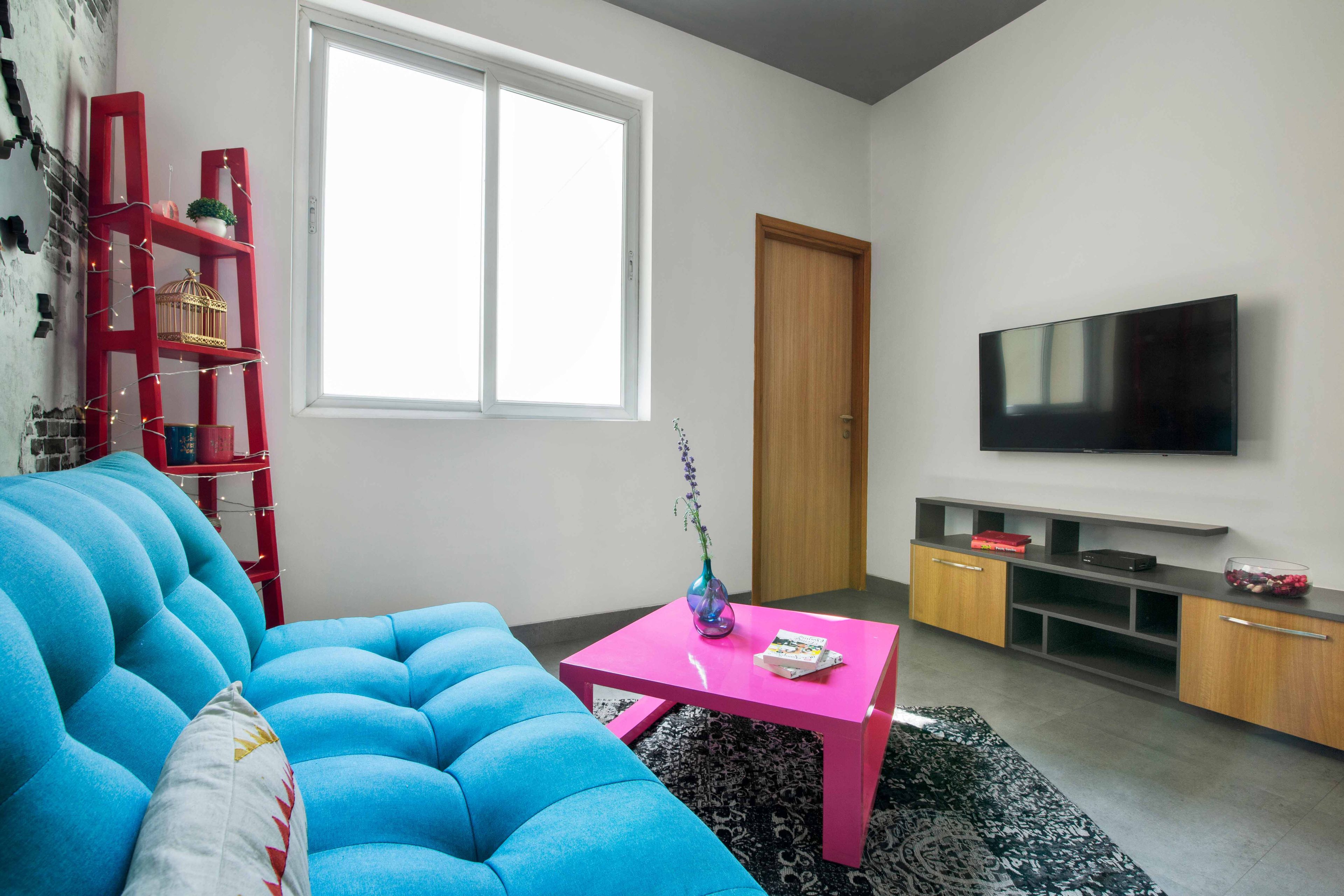 Family Room With Blue Sofa, 3D World Map Wall Design With Industrial Look And TV Unit - Livspace