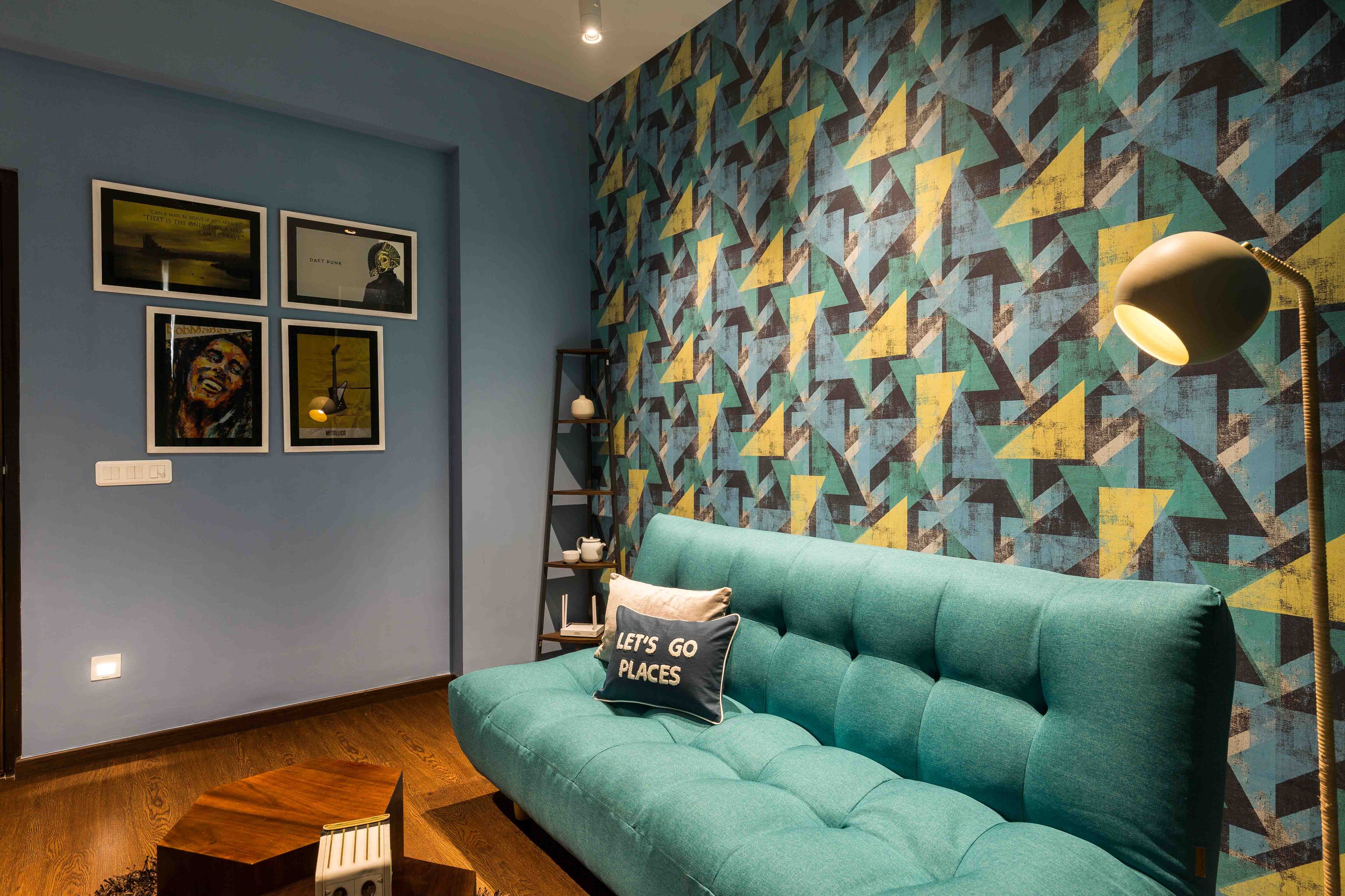 Home Theatre Design with Blue Low Seated Sofa and Patterned Wallpaper - Livspace