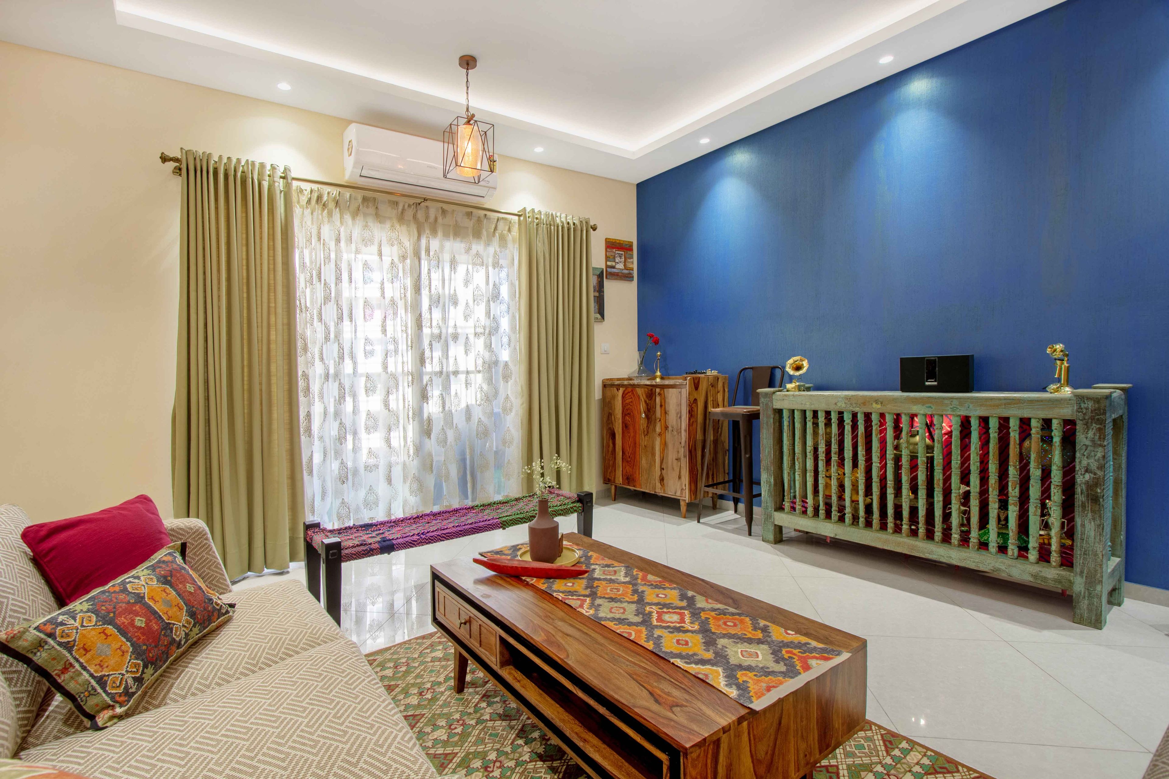 Living Room Design with Wooden Coffee Table, Seating Bench and Blue Walls - Livspace